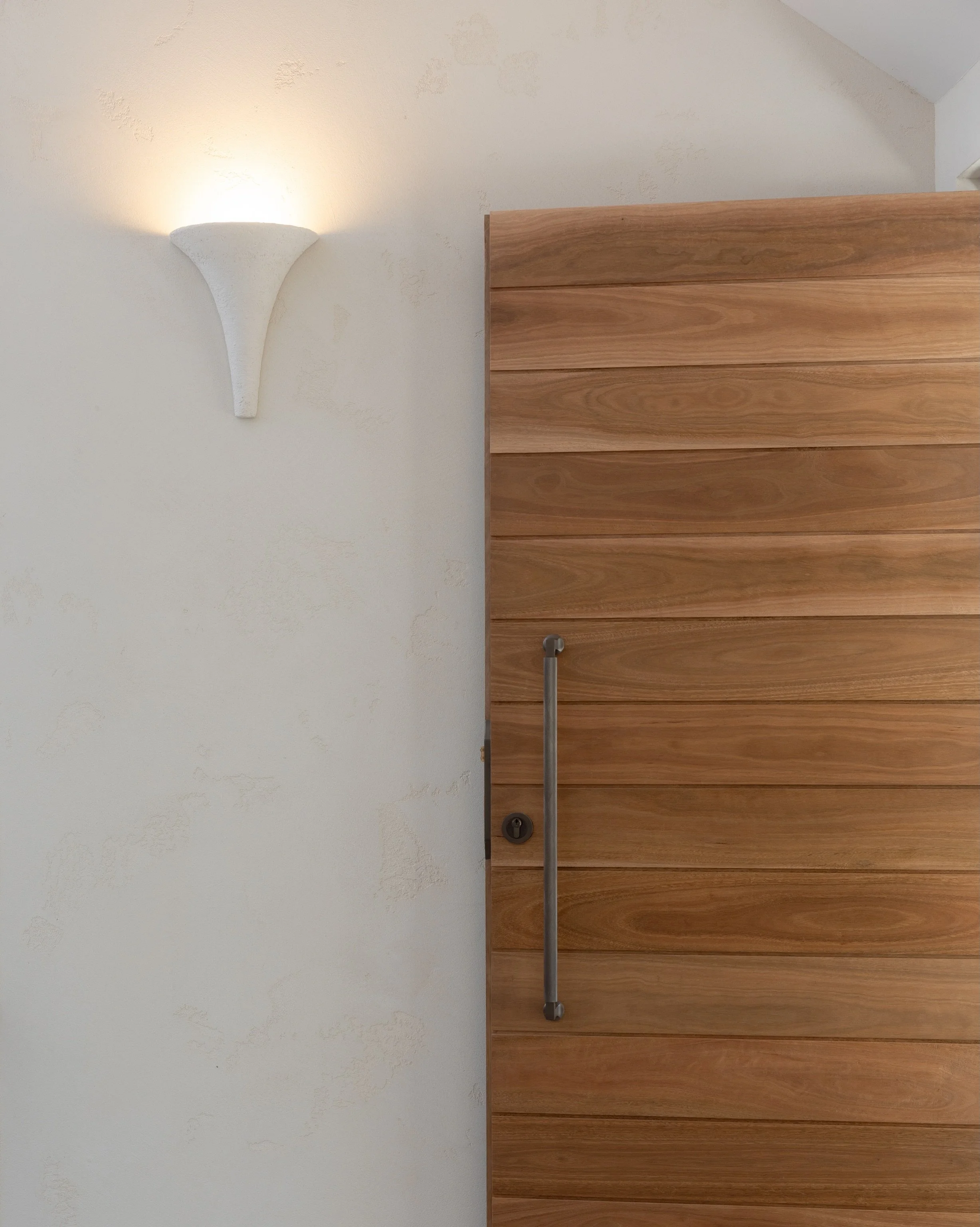 🚪A front door should feel like a quiet introduction, this one speaks in warmth and texture.

Crafted by @loughlinfurniture in spotted gum with a refined shiplap detail, the door is anchored by the @iver_life Brunswick pull in Signature Brass, bringi