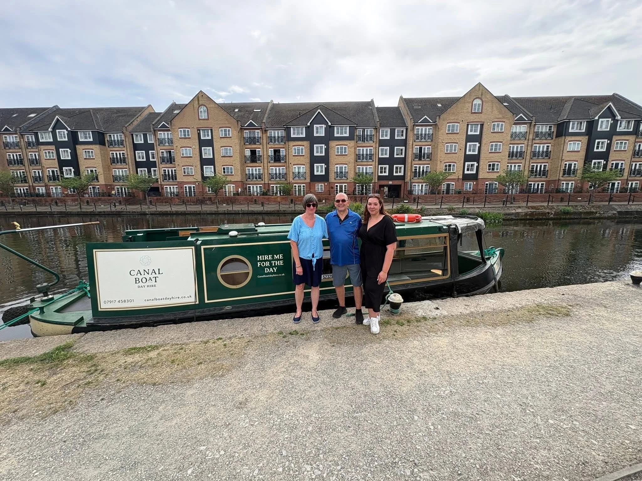 A family standing next to Tilly the narrowboat outside of Apsley Marina on the Grand Union Canal in Hemel Hempstead