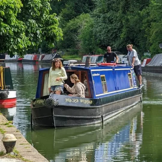A family enjoying a relaxed day together on a narrowboat along the Grand Union Canal at Apsley.