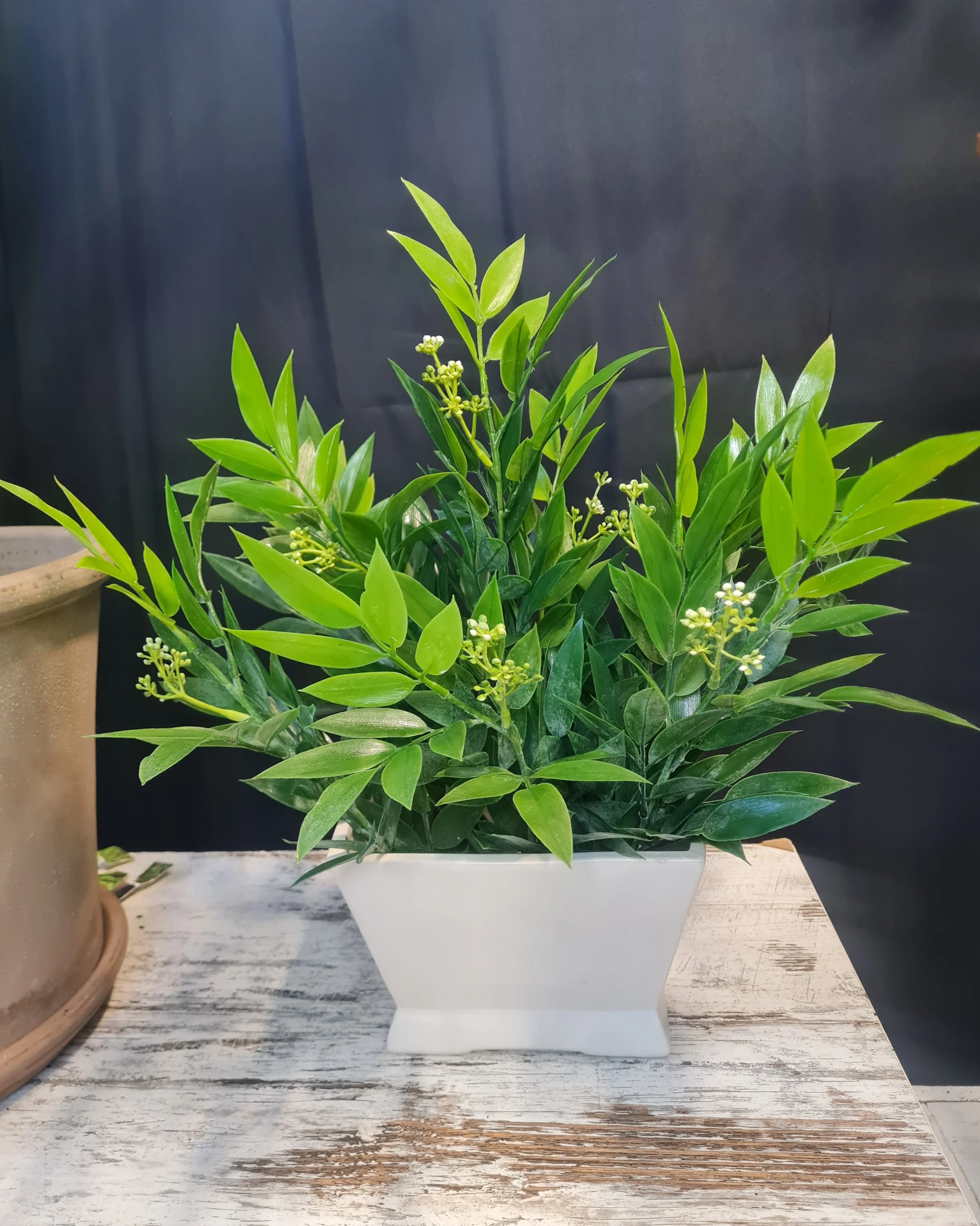Artificial Eucalyptus leaves with white pot