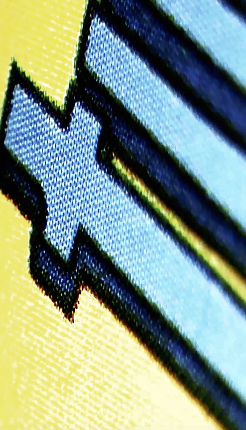 Close-up of a digital screen displaying a blue arrow pointing downward, with a yellow background.