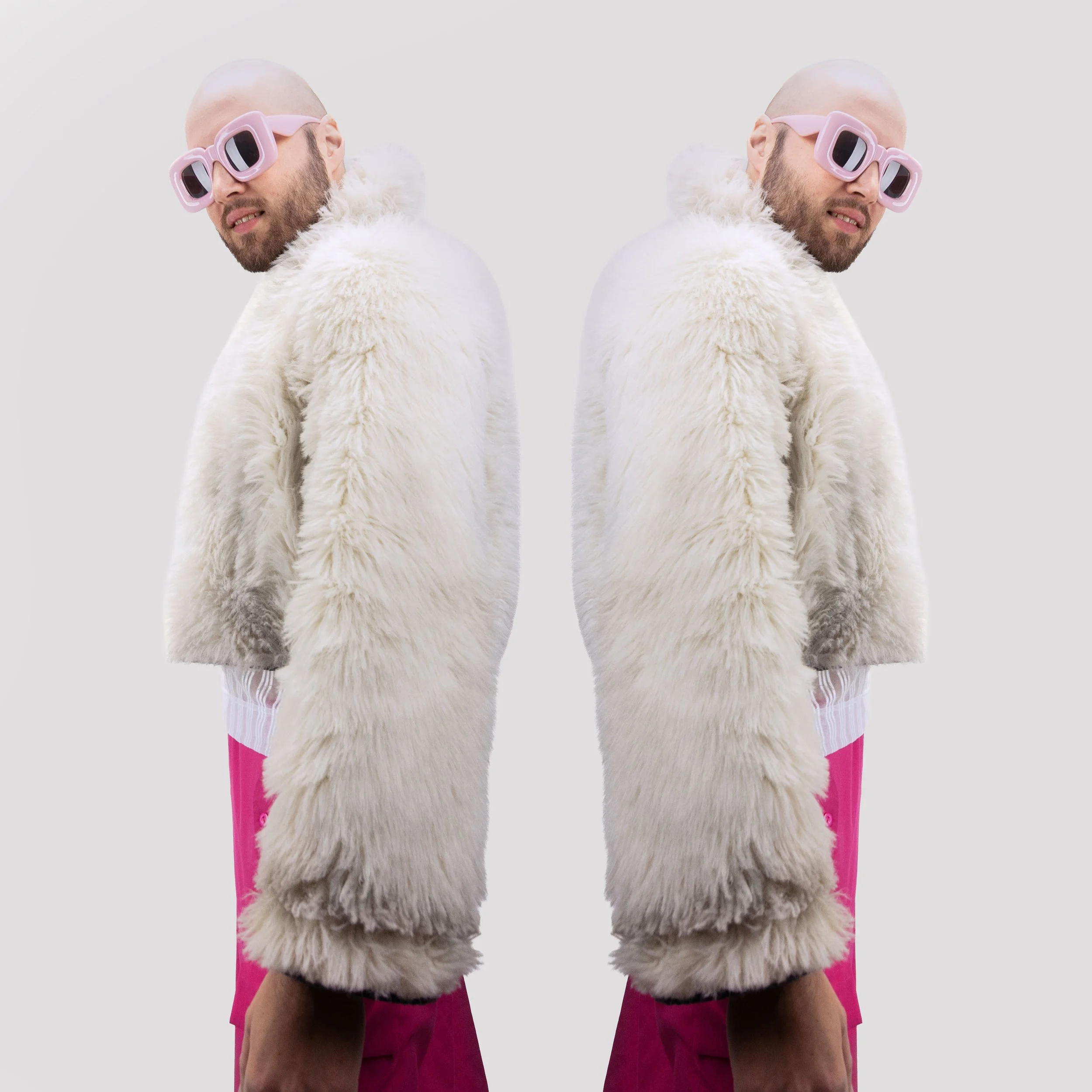Man with a beard wearing pink sunglasses, white furry coat, and pink pants, reflected in mirror.