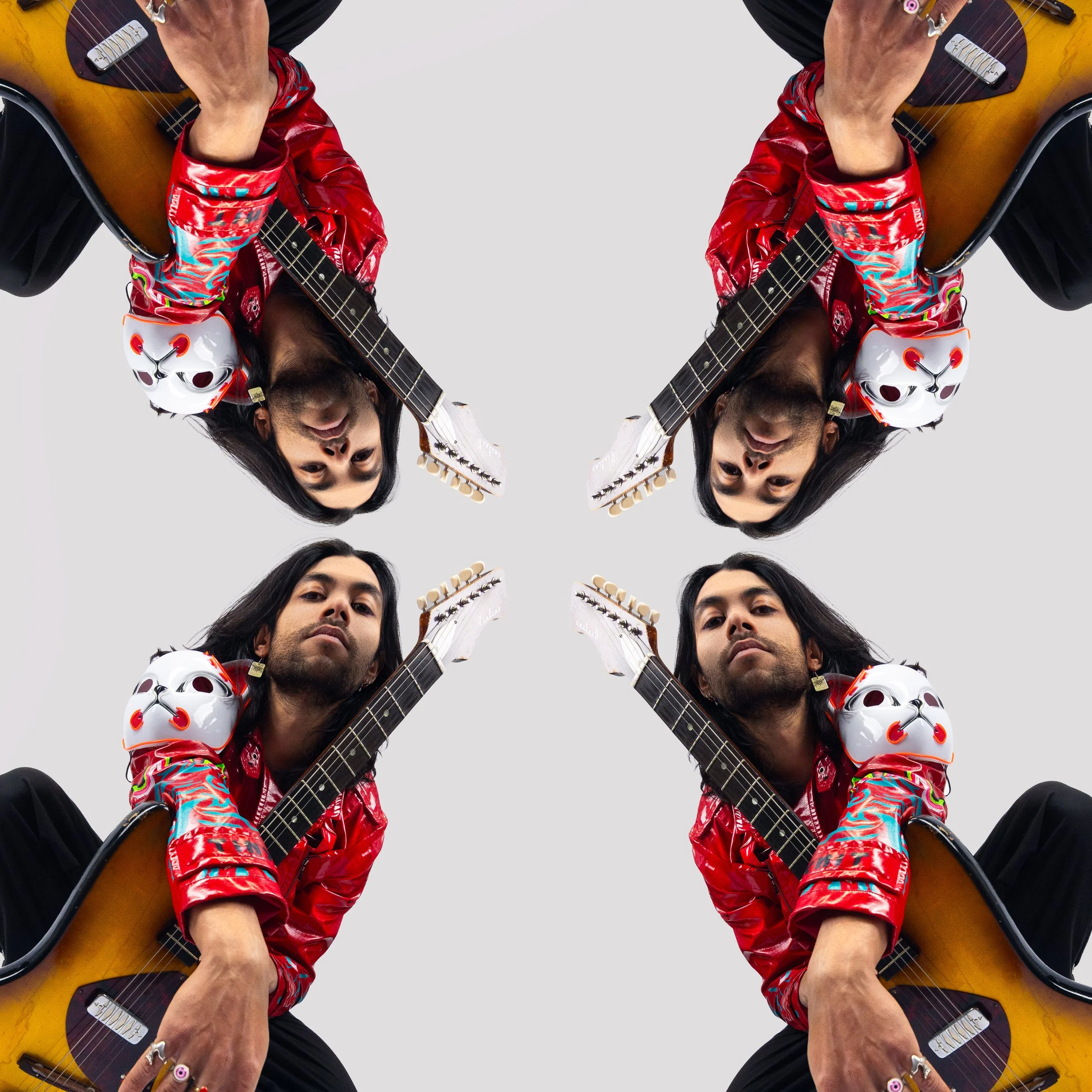 Four individuals with long dark hair and beards, dressed in red shiny jackets and black pants, sitting with acoustic guitars and white fox masks on their shoulders, arranged in a mirrored pattern against a plain white background.