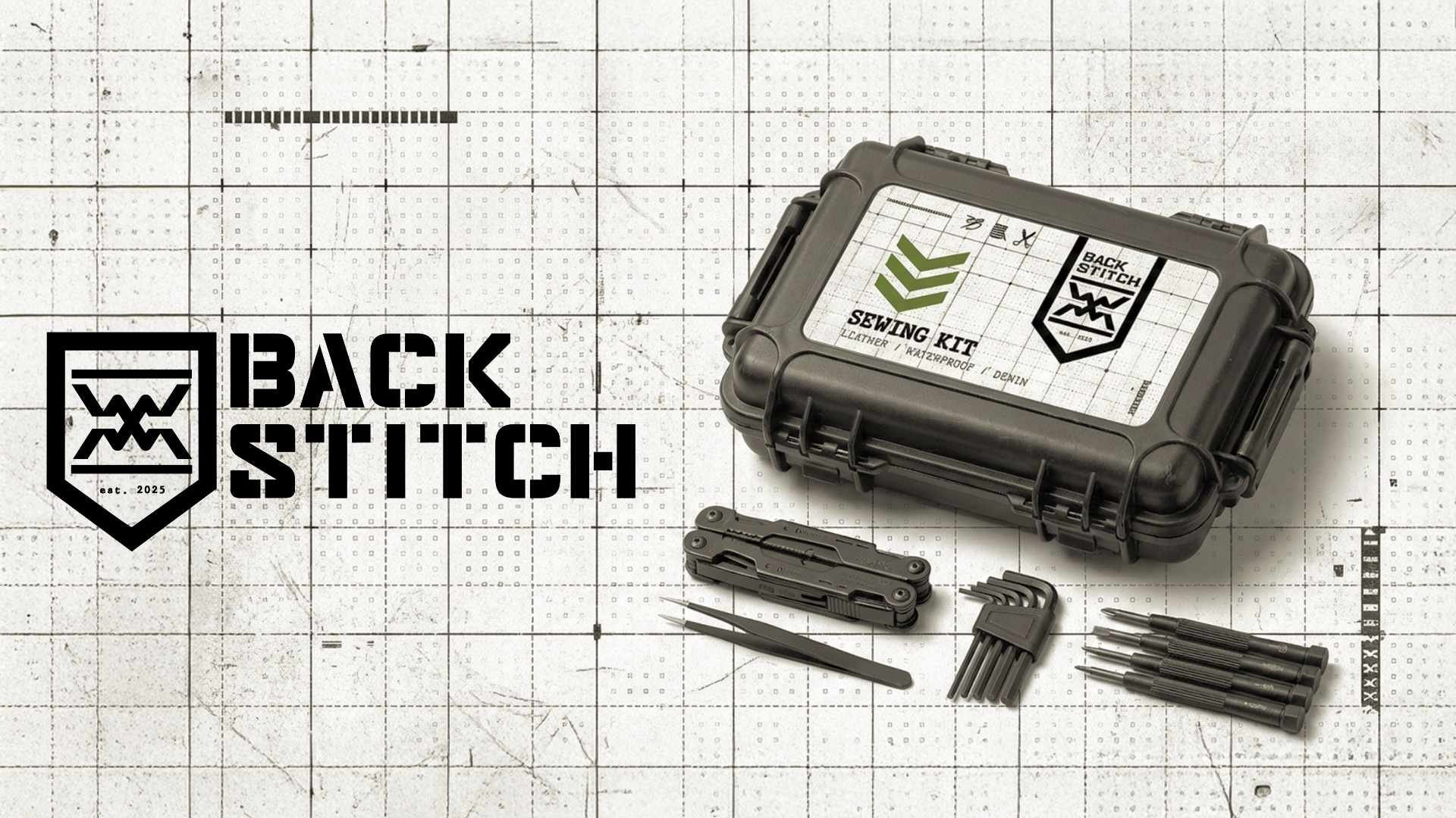 Back Stitch sewing kit with scissors, screwdriver, Allen keys, screwdrivers, and tweezers on a cutting mat with grid lines.