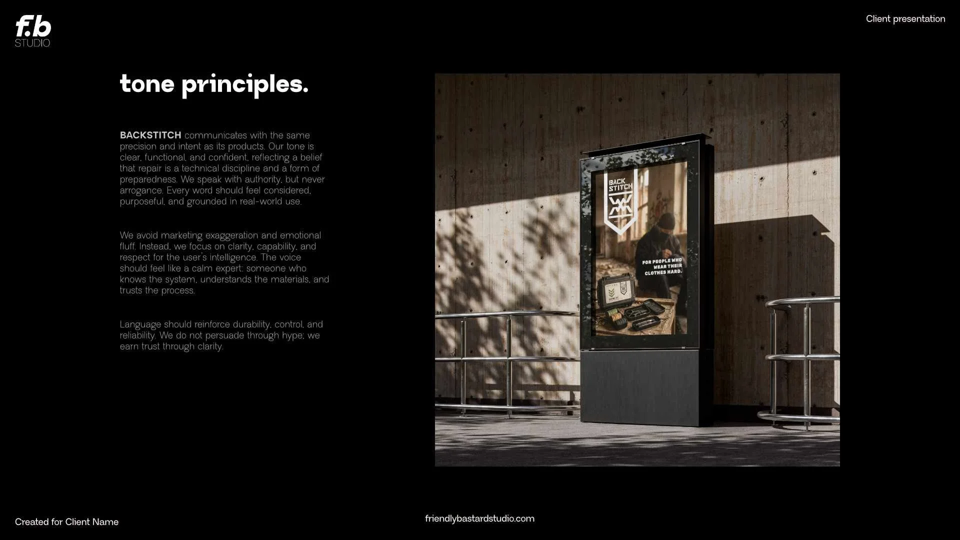 A digital display advertising poster for Back Stitch, a clothing repair service, placed on a sidewalk with a wooden wall background and shadows of leaves.