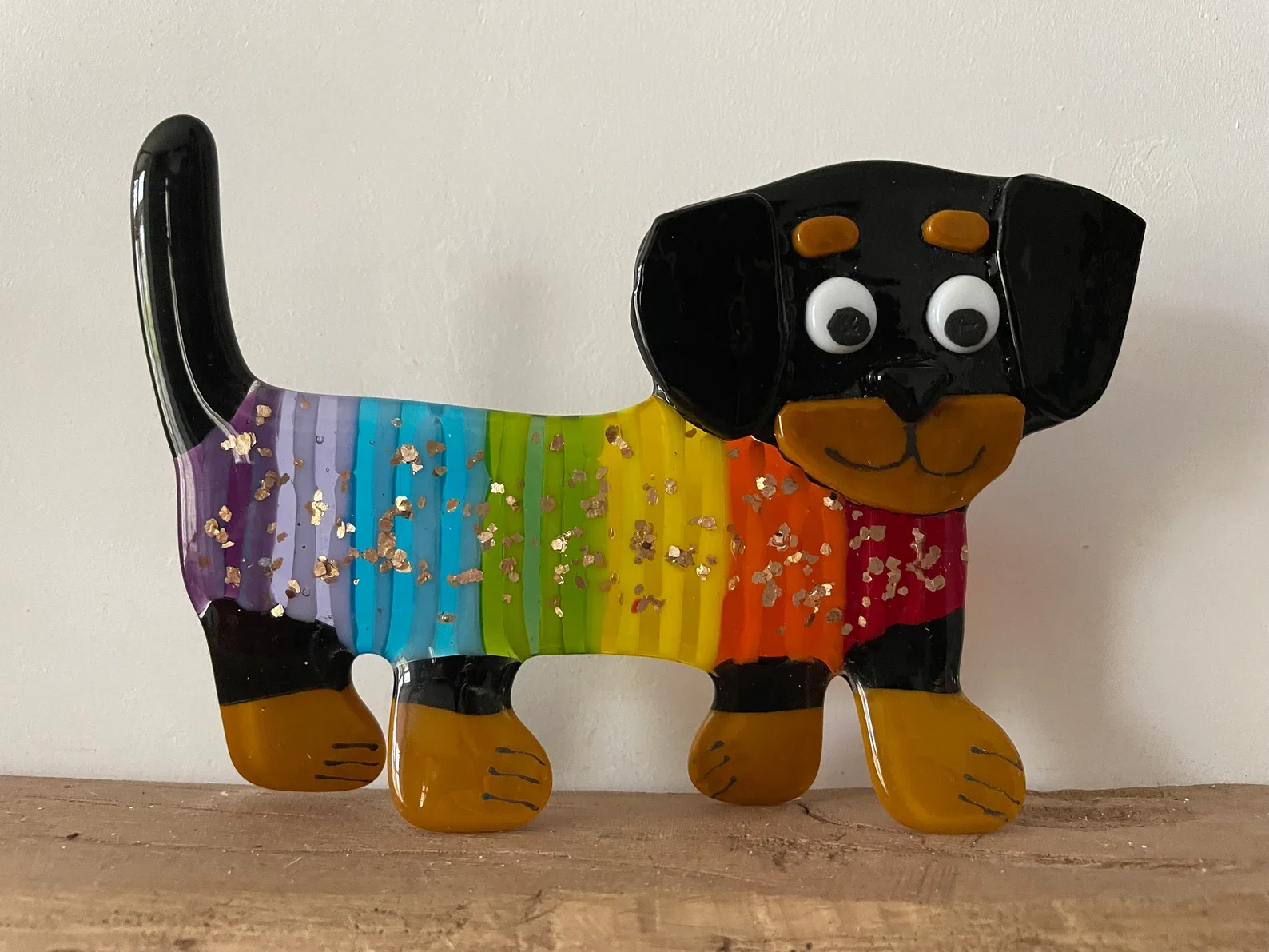 Stand up fused glass rainbow coat wearing dachshund, sausage dog