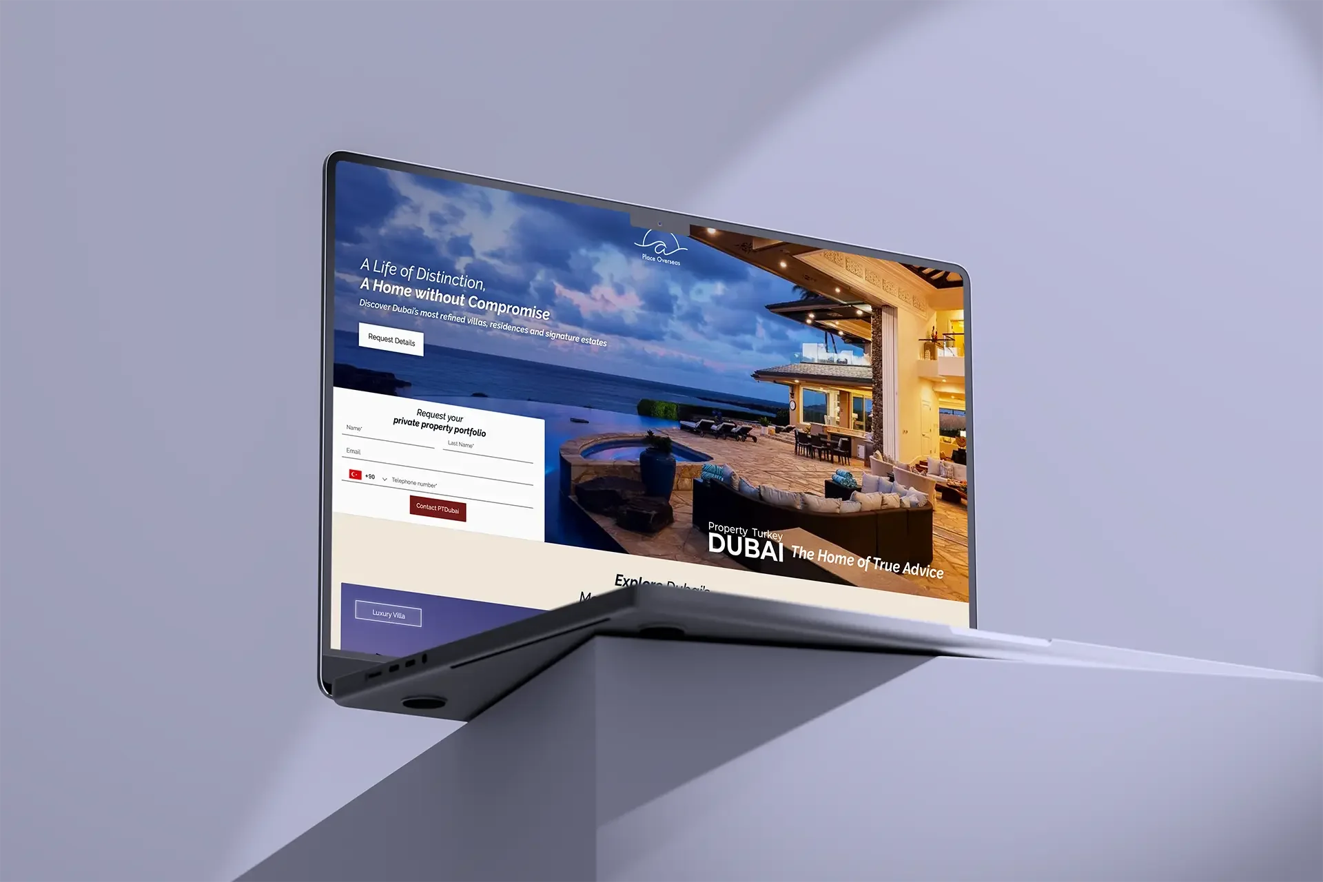 Laptop displaying a real estate website for properties in Dubai, showcasing an outdoor patio with lounge furniture, a pool, and ocean view, with a form to request details.