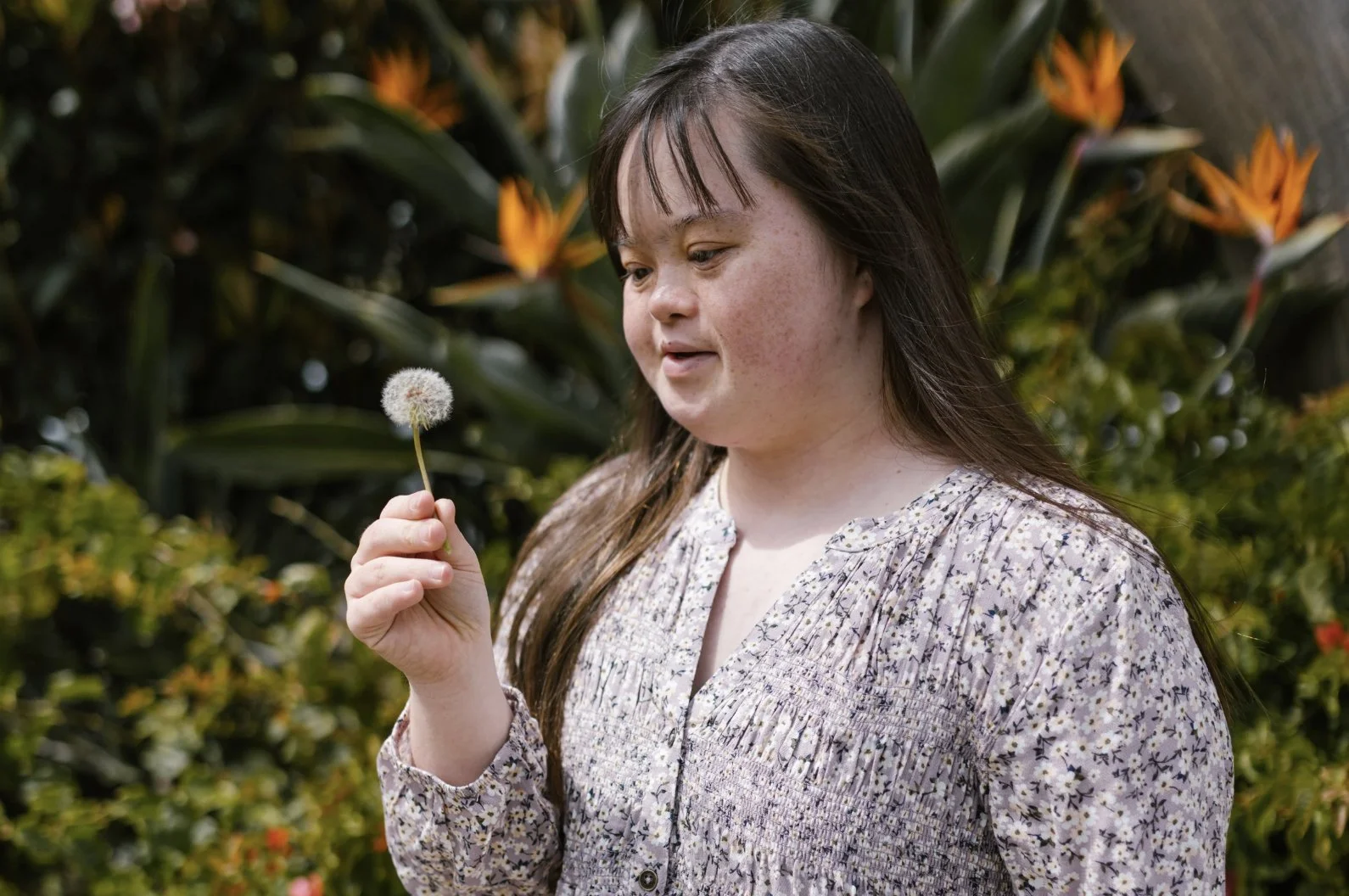 young-girl-holding-dandelion