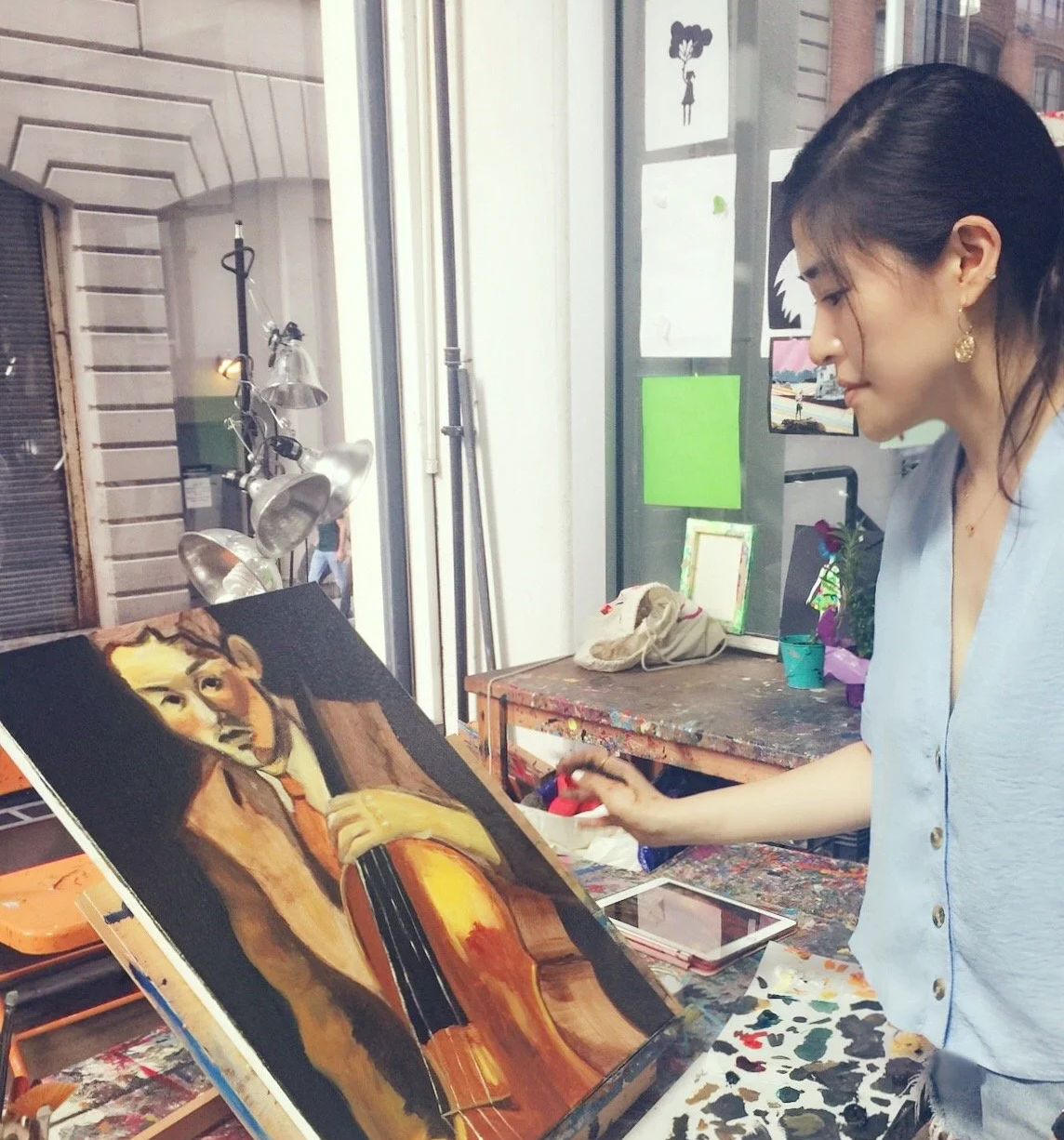 Artist Jaime Lee Girard studying work by Lee Quede.