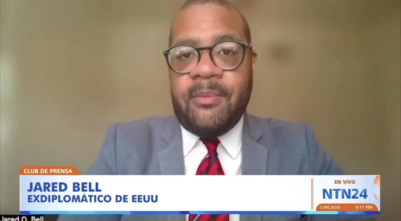 Screenshot of a television news interview with Jared Bell, labeled as a U.S. ex-diplomat, live broadcast on NTN24 channel, showing the time as 4:11 PM in Chicago.