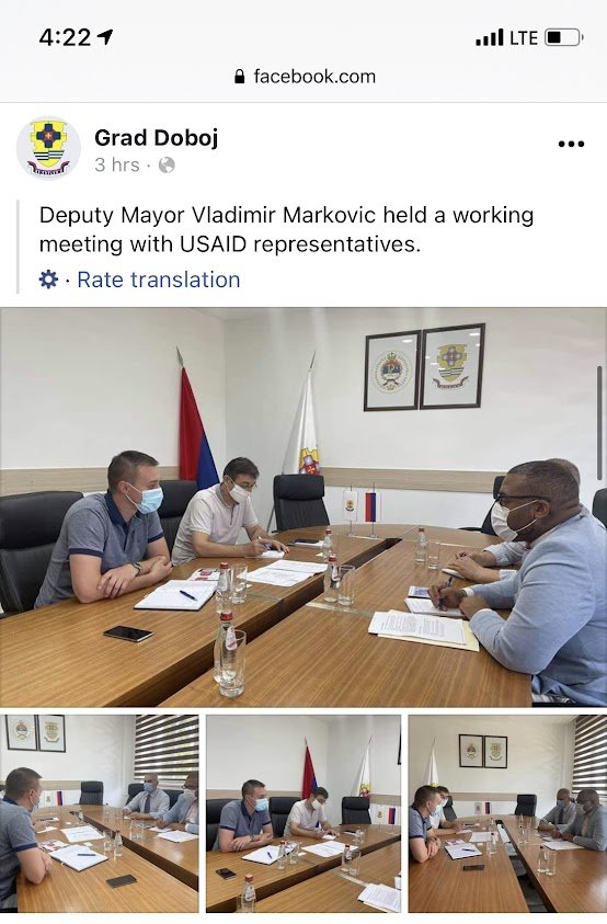 Deputy Mayor Vladimir Markovic and officials in a meeting room with flags and framed crests, wearing masks and seated at a wooden conference table.