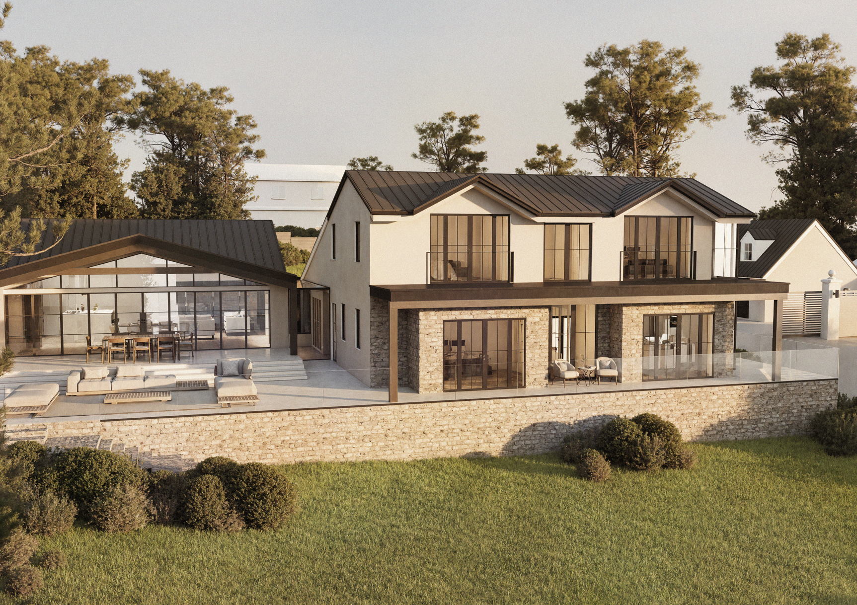 Modern two-story house with glass sliding doors, a stone patio with outdoor furniture, and a glass railing, surrounded by trees and greenery.