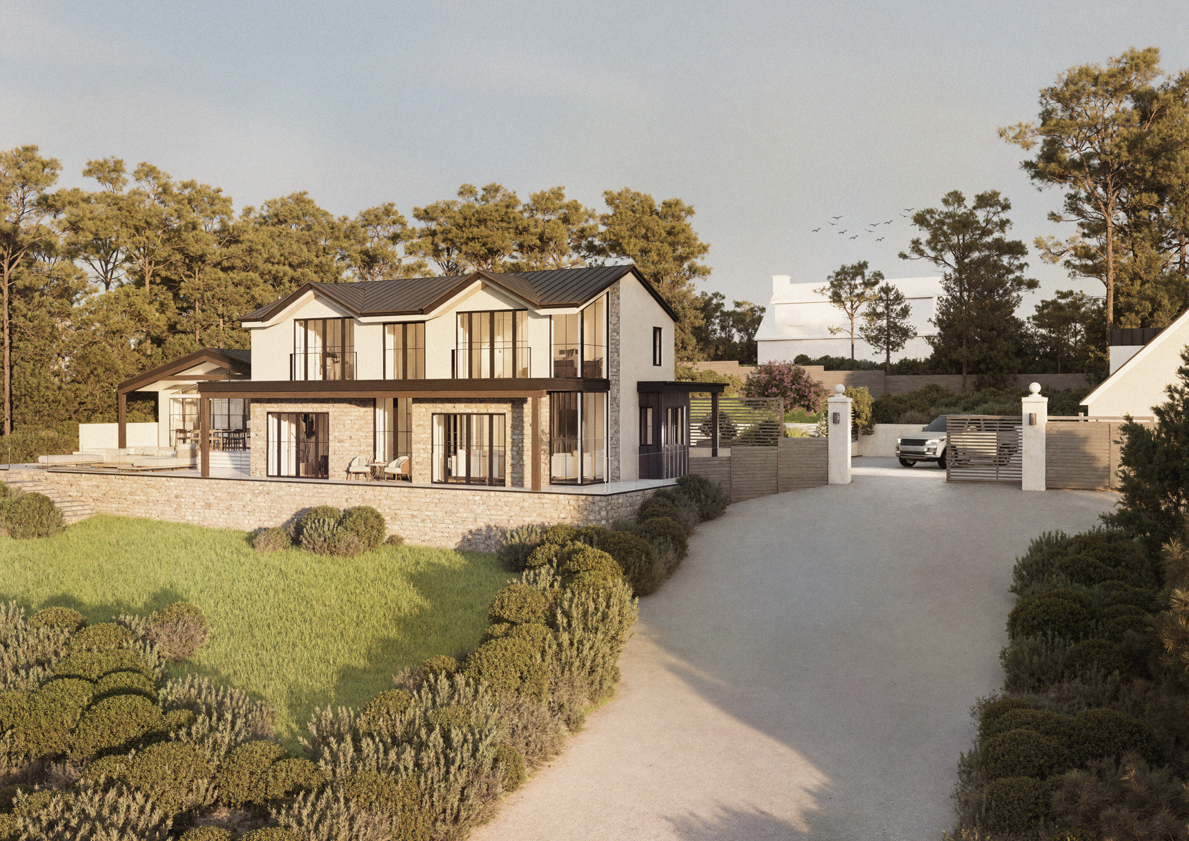 Modern two-story house with large glass windows, stone and white exterior, surrounded by greenery and trees, with a gravel driveway leading to a gated entrance.
