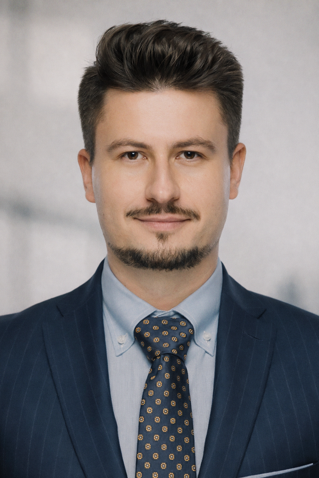 Portrait of Nenad Ristic, CEO of Stavrok, in a dark blue suit and patterned tie, looking directly at the camera with a calm, confident expression.