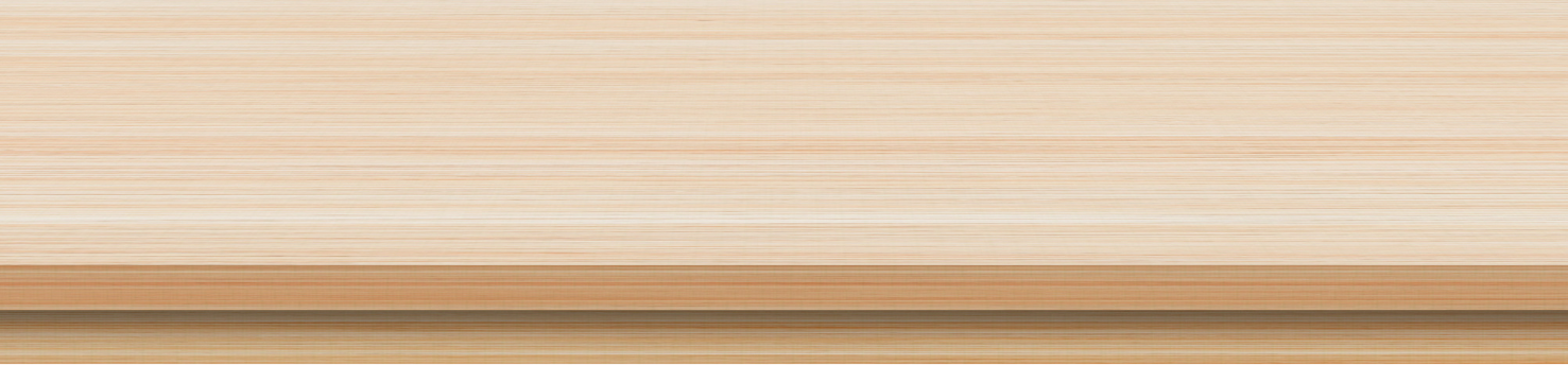 A close-up view of a wooden surface, showing natural wood grain and texture with light and dark streaks.
