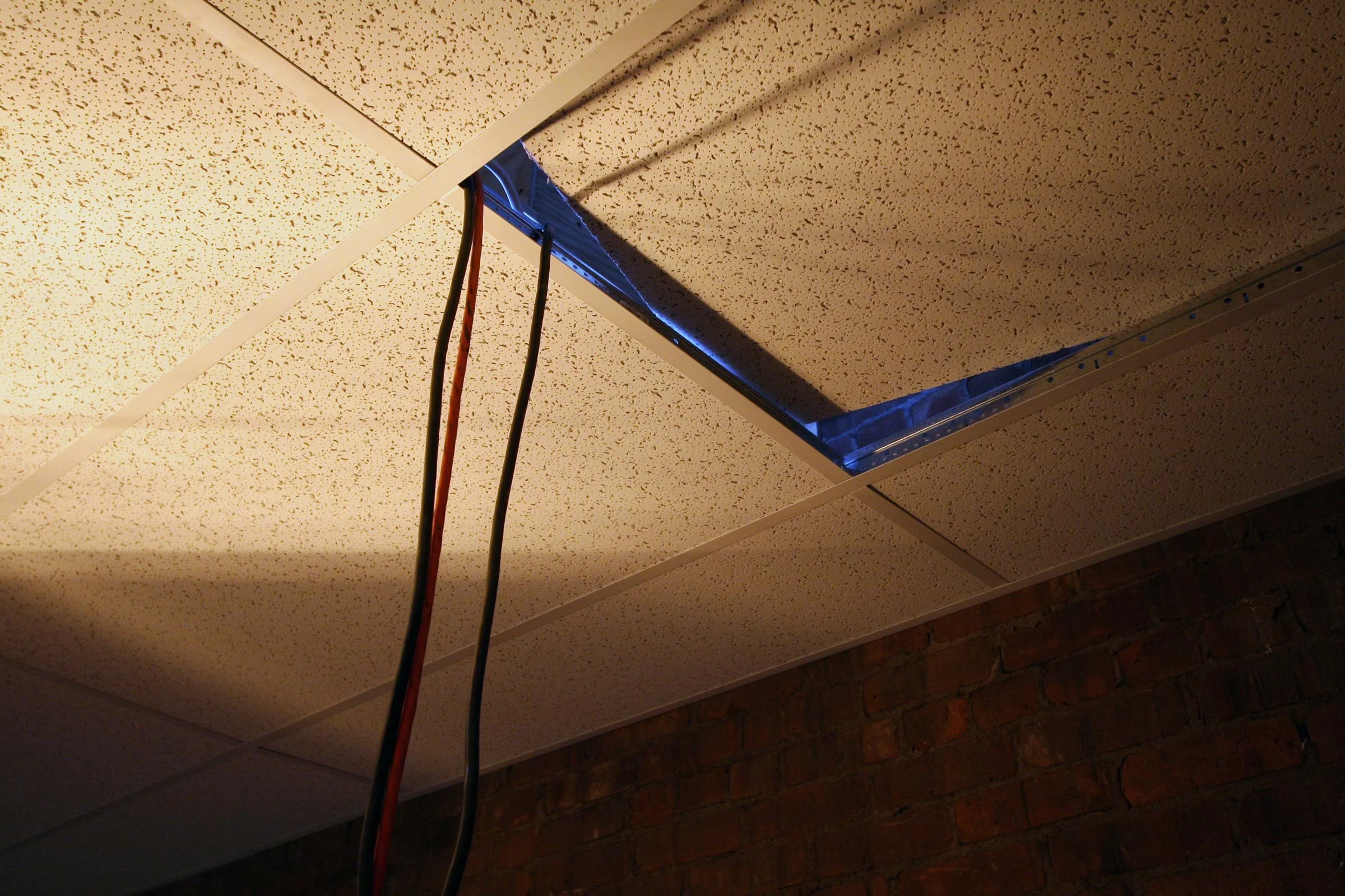 Extension cords hang as if the site is under construction.