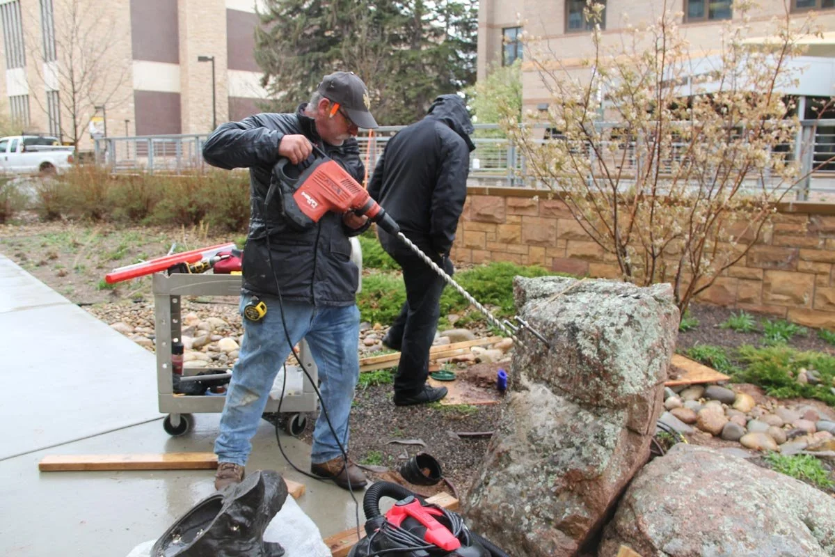 Drilling all the way through boulders .