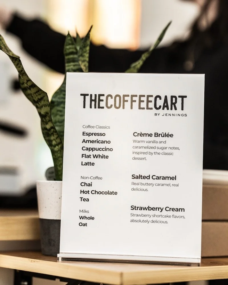 Menu card for The Coffee Cart with coffee, non-coffee, and milk options, and descriptions of Crème Brûlée, Salted Caramel, and Strawberry Cream