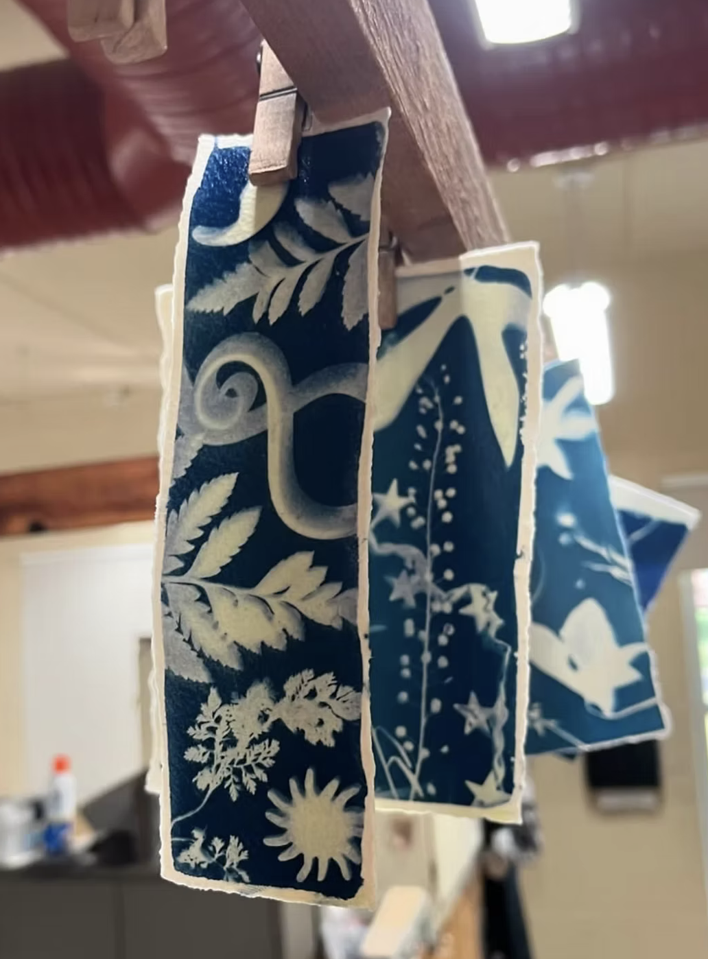 Cyanotype Prints - A printing method where a special type of ink is painted on paper, objects are then places on top of the ink/paper and sat in the sun until the ink turns blue, once the objects are removed you get a cyanotype print.