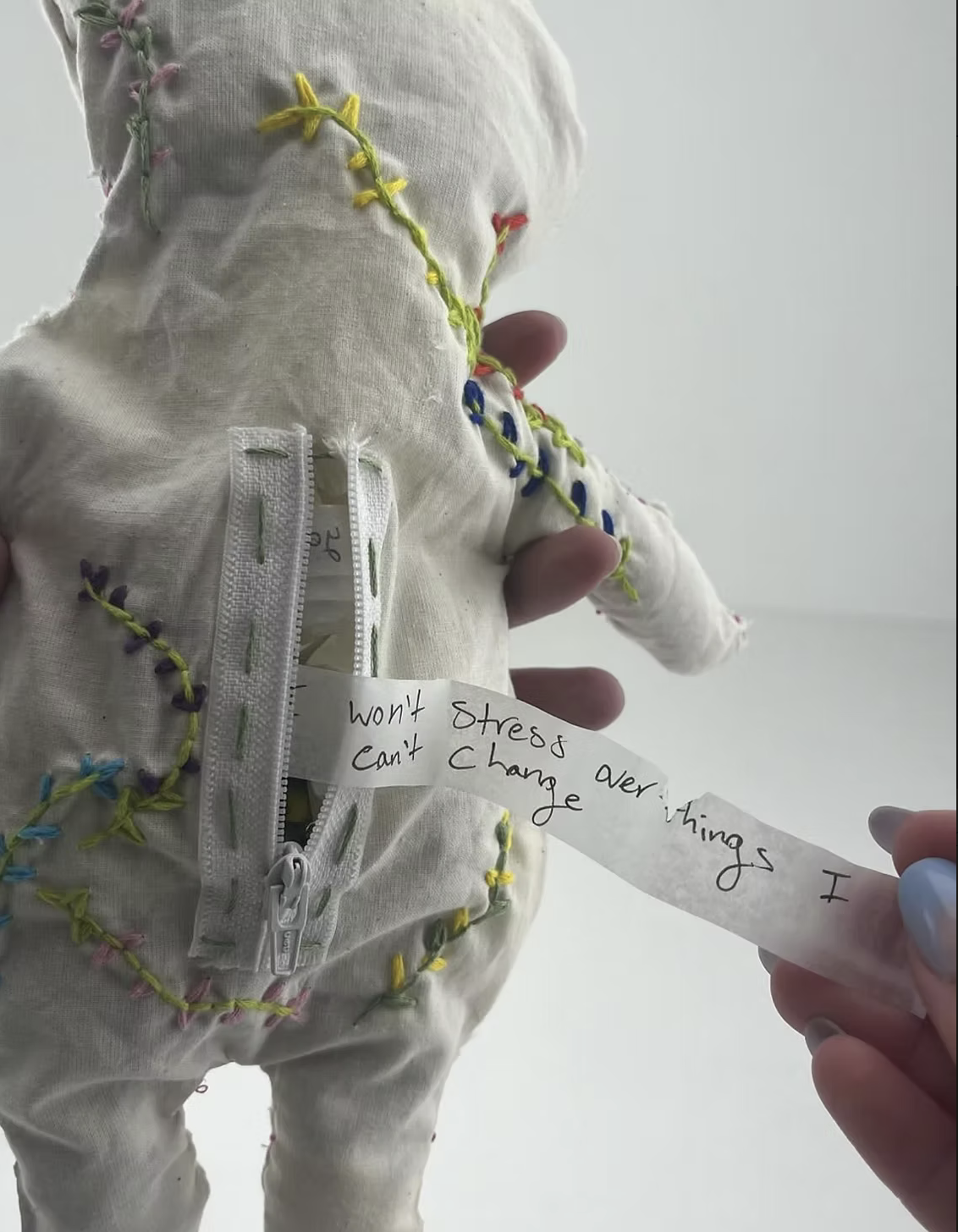 The Positivity Dummy - Given three materials, cloth, twine, and paper and creative freedom, I made the positivity dummy. Hand sewn with love, he holds little notes of positive affirmations to bring light into everyone's day.