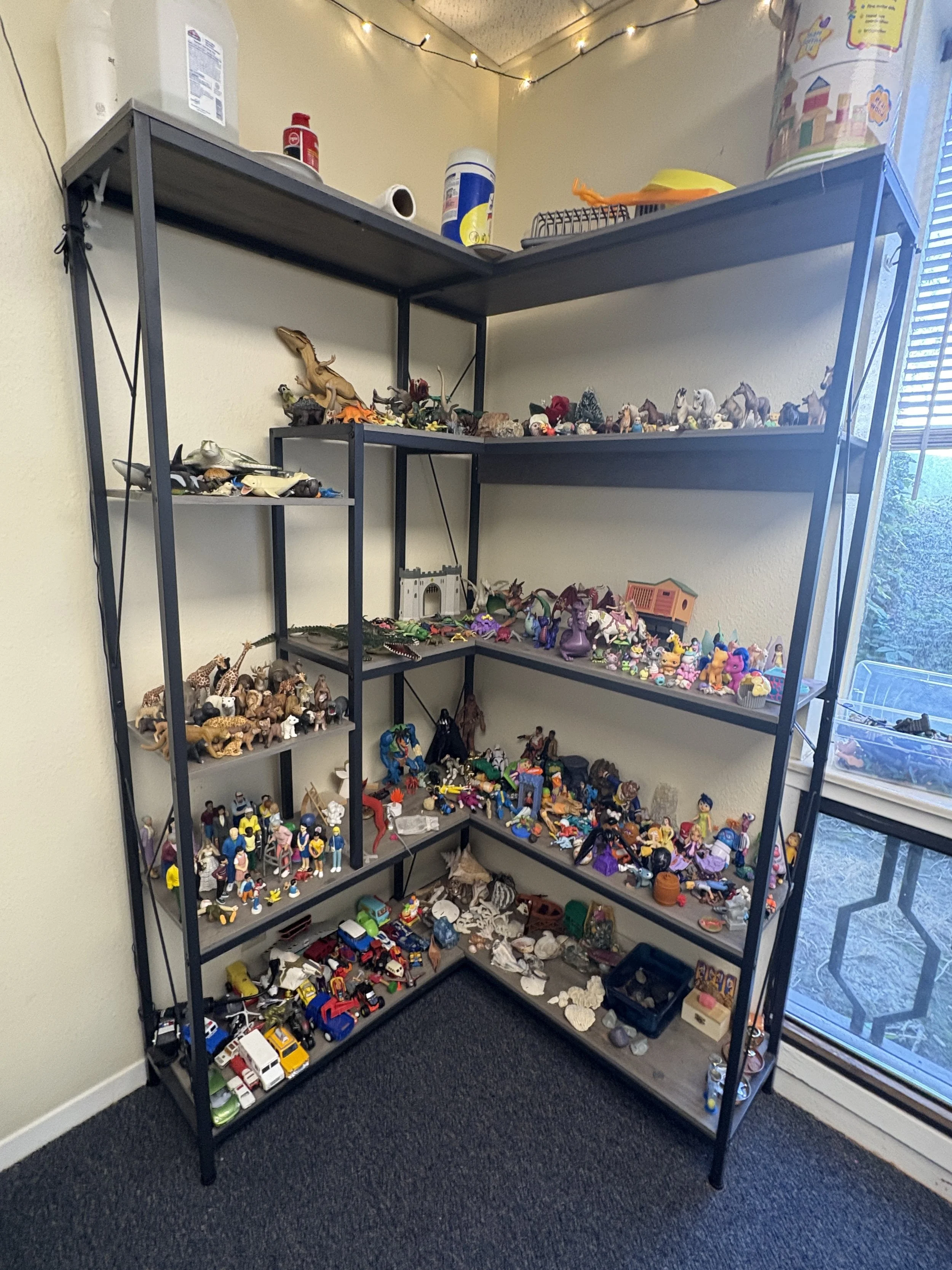 Shelf of sand tray toys, toys, and Items