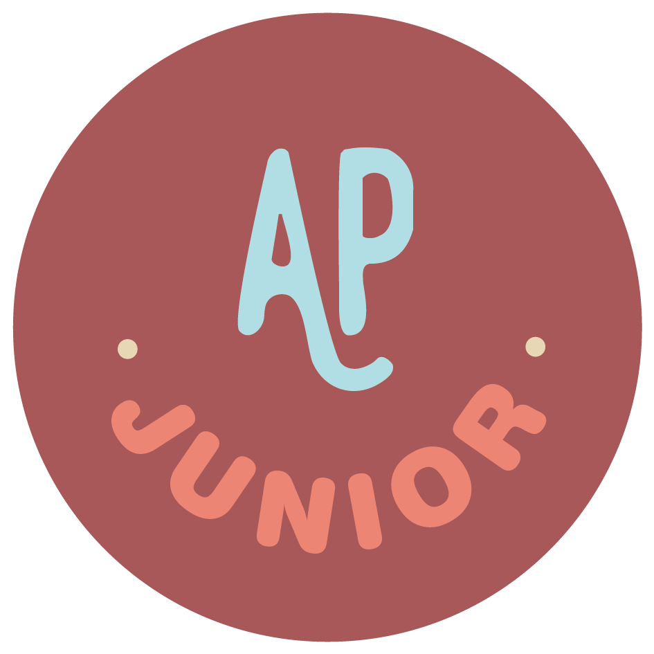 Circular logo with a dark pink background. The letters 'A' and 'P' are in large light blue font at the center. The word 'JUNIOR' is in smaller peach-colored font arched along the bottom.