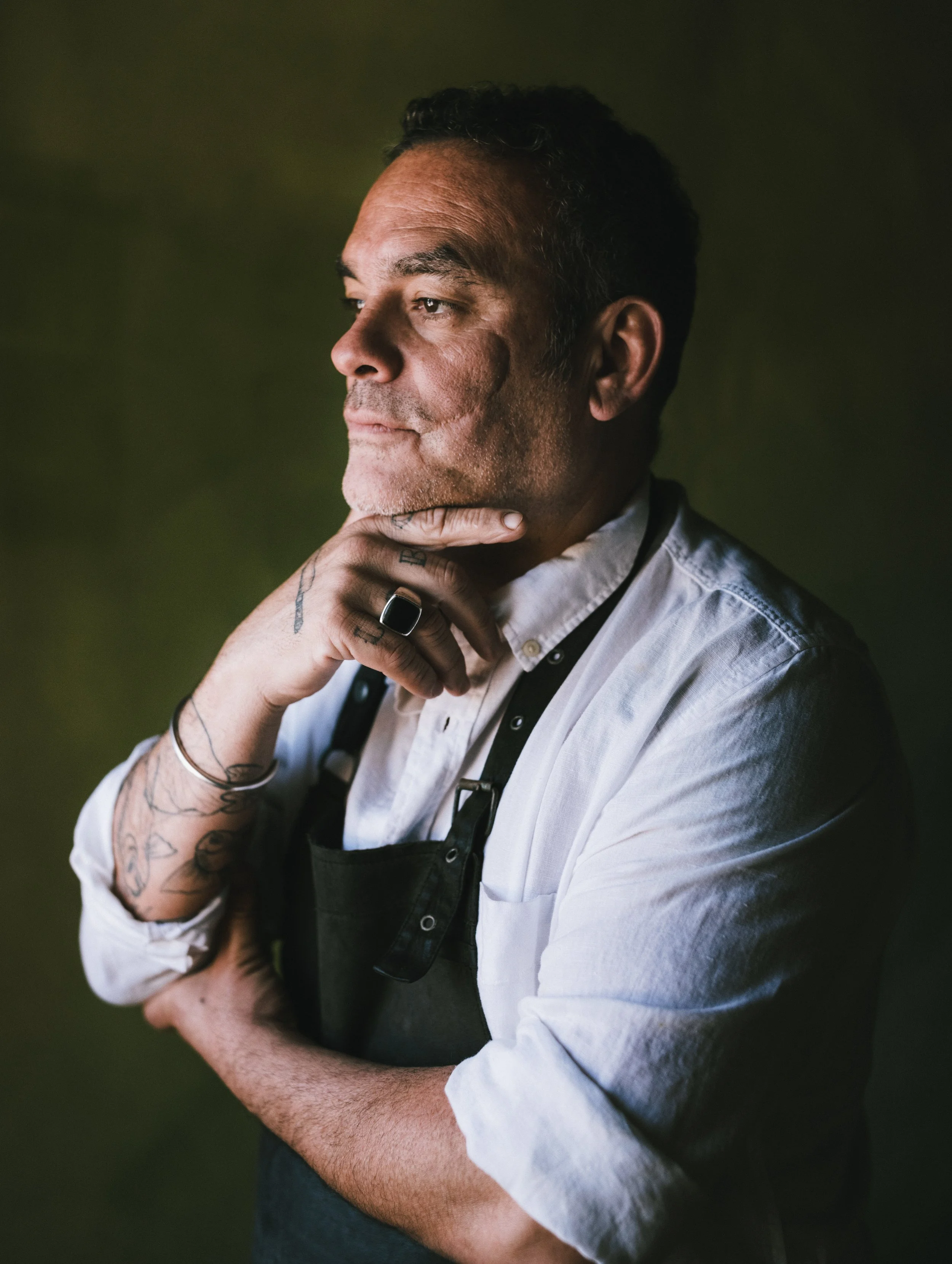 A quiet portrait session with Martin, a wood-fire chef, where light and atmosphere emphasize contemplation, patience,  thoughtful expression, and presence.