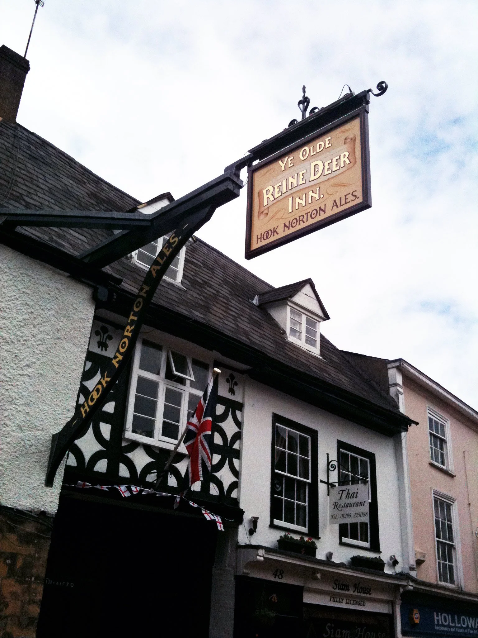 Sign for Ye Olde Reine Deers Inn hanging outside a building.