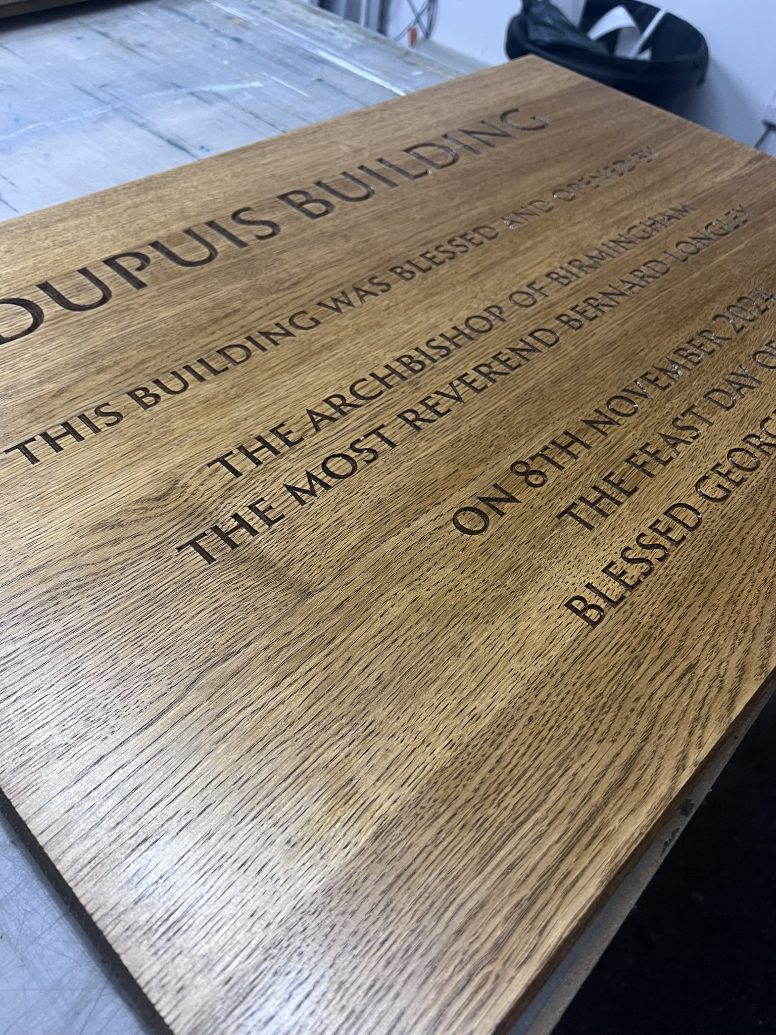 A wooden plaque with engraved text that reads: 'I KNOW THE PLANS I HAVE FOR YOU, DECLARES THE LORD.').