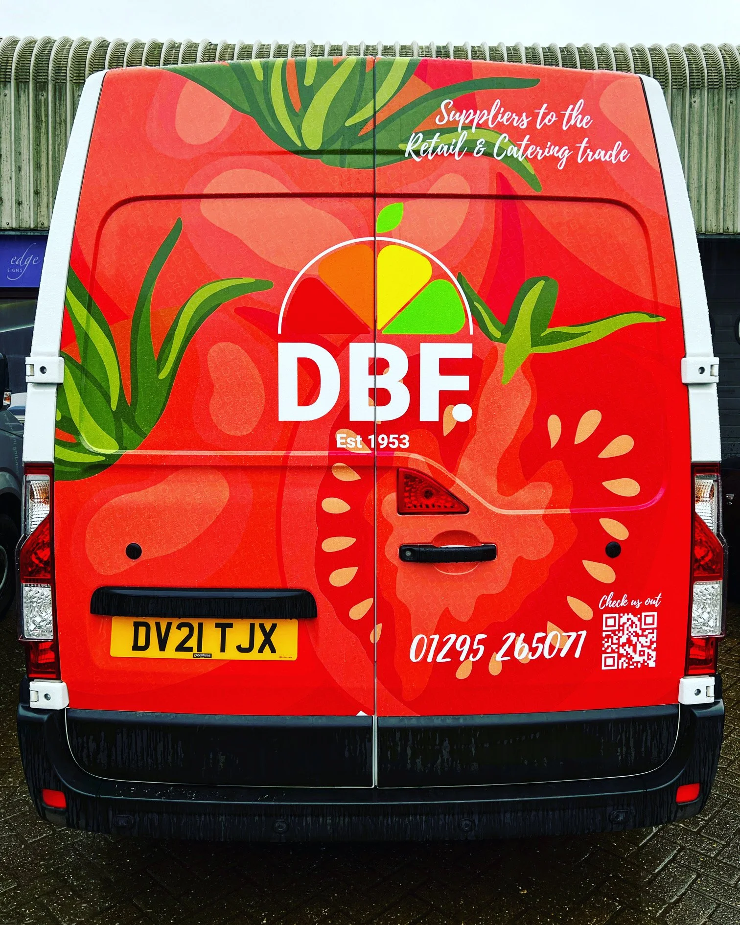 Red van with a large strawberry graphic design and branding for a company named DBF, established in 1953. The van has the company's phone number and a QR code on the back.