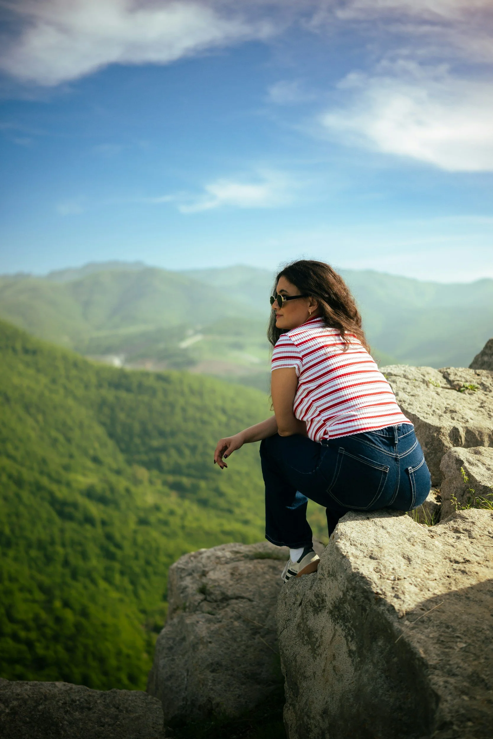 A person sitting alone on a mountain overlook in Colorado, symbolizing the balance between independence and isolation.