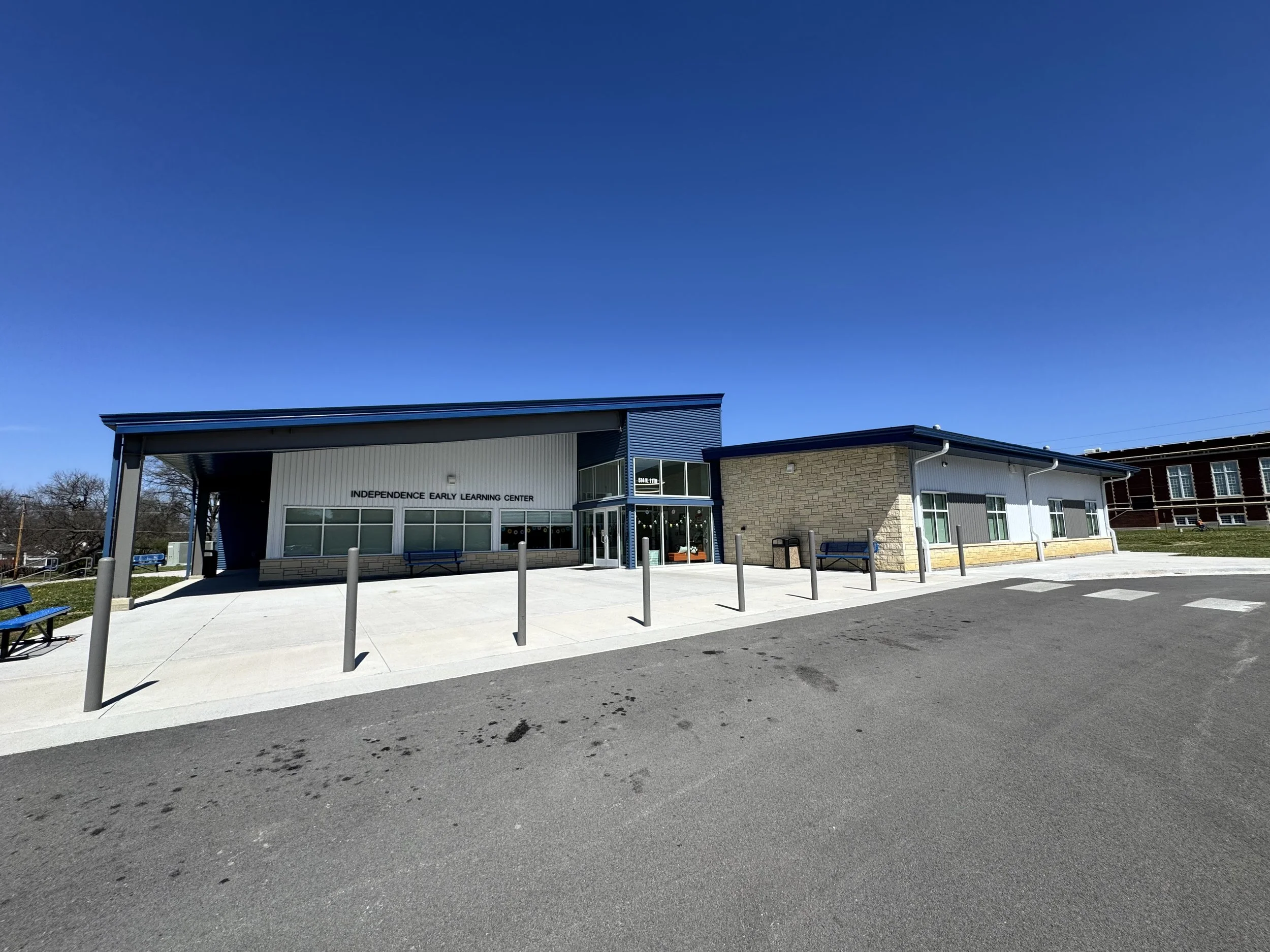 Front view of the Independence Early Learning Center building with clear blue sky and sidewalk in the foreground.