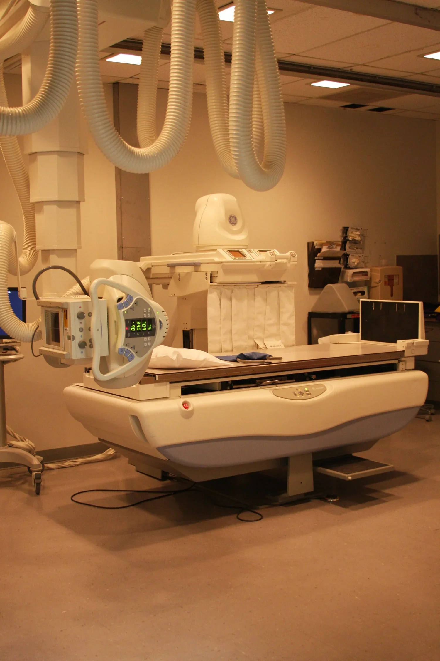 Hospital room with an x-ray machine and imaging equipment.
