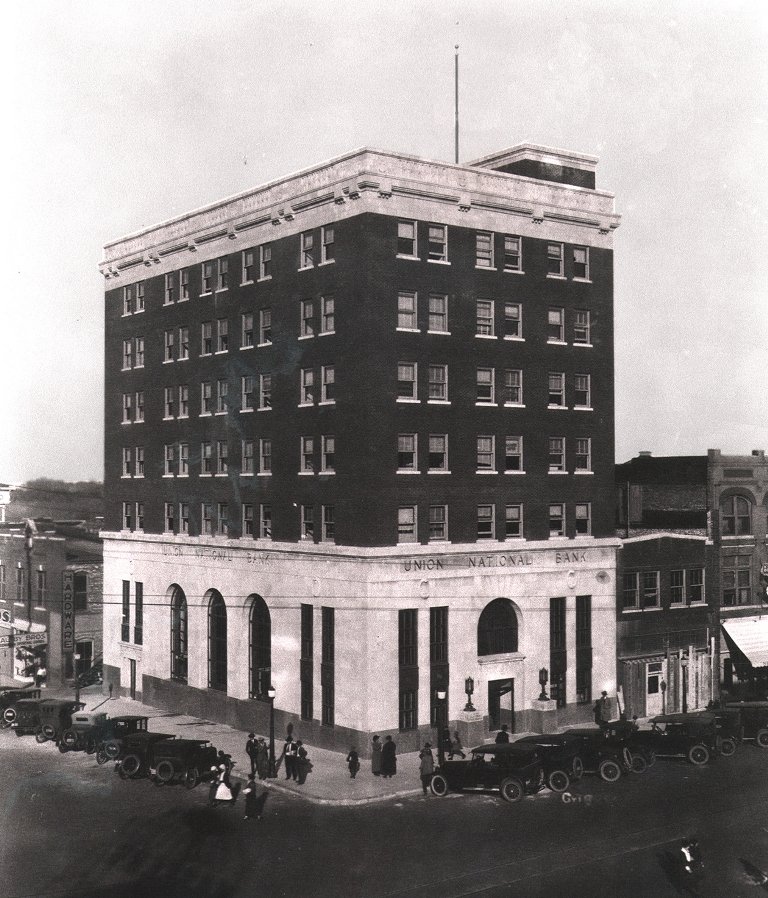 Black and white photo of a multi-story brick building with 