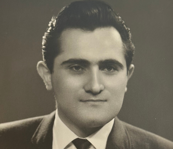 Black and white portrait of Shahen Guiragossian from the 1960s with neatly combed dark hair, wearing a suit and tie.