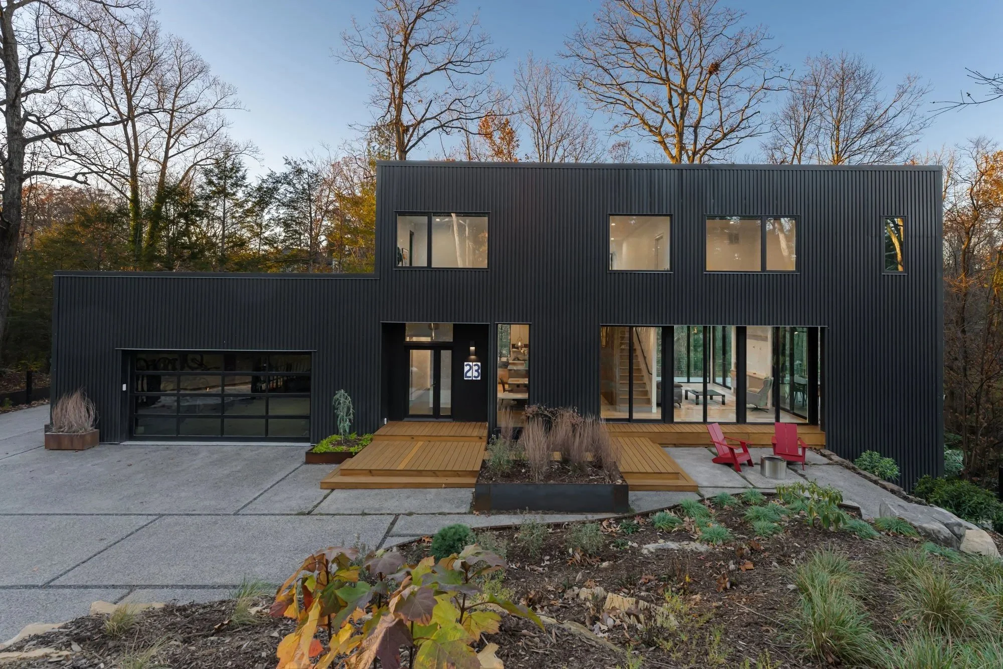 Weaver Exterior black corrugated metal facade with large glass windows and garage door.