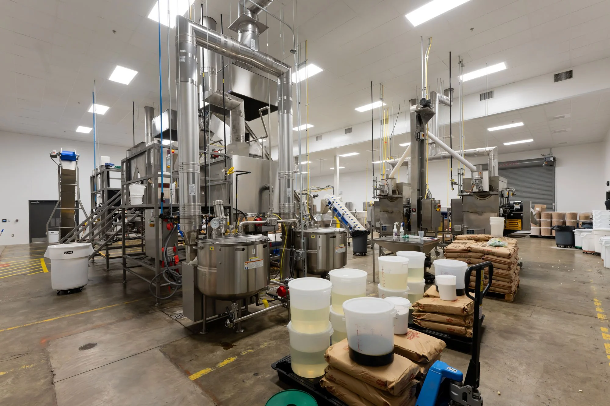 Poppy's Popcorn Interior with kettles, poppers, seasoning equipment, and conveyors.