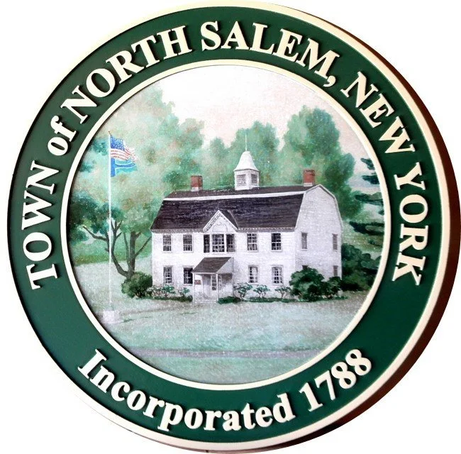 Seal with central illustration of a historic white house with a cupola, trees, and an American flag; surrounded by green border text reading 'Town of North Salem, New York' and 'Incorporated 1788'.