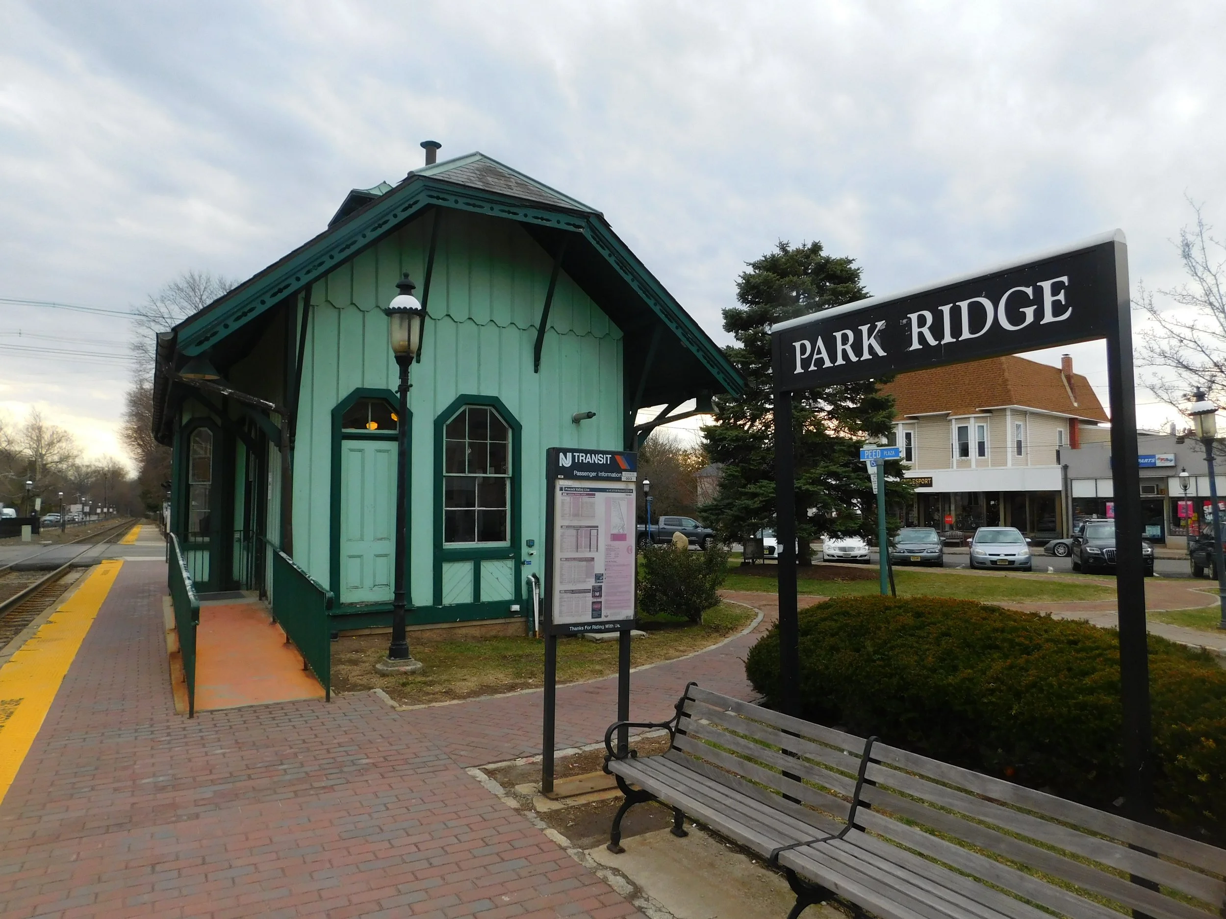 Small green train station building with a
