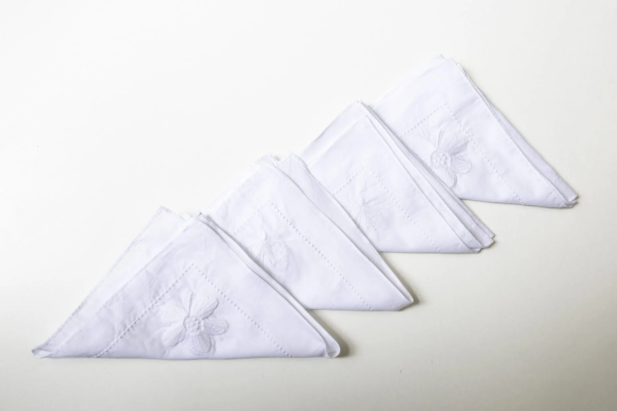 Four  Embroidered Napkins