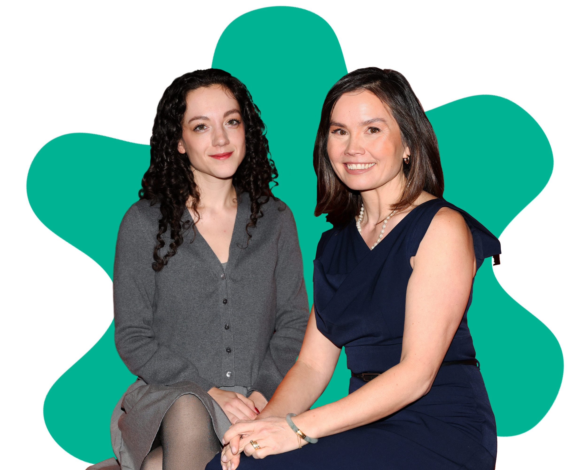 Two women sitting close together, smiling at the camera, with a teal heart shape in the background.