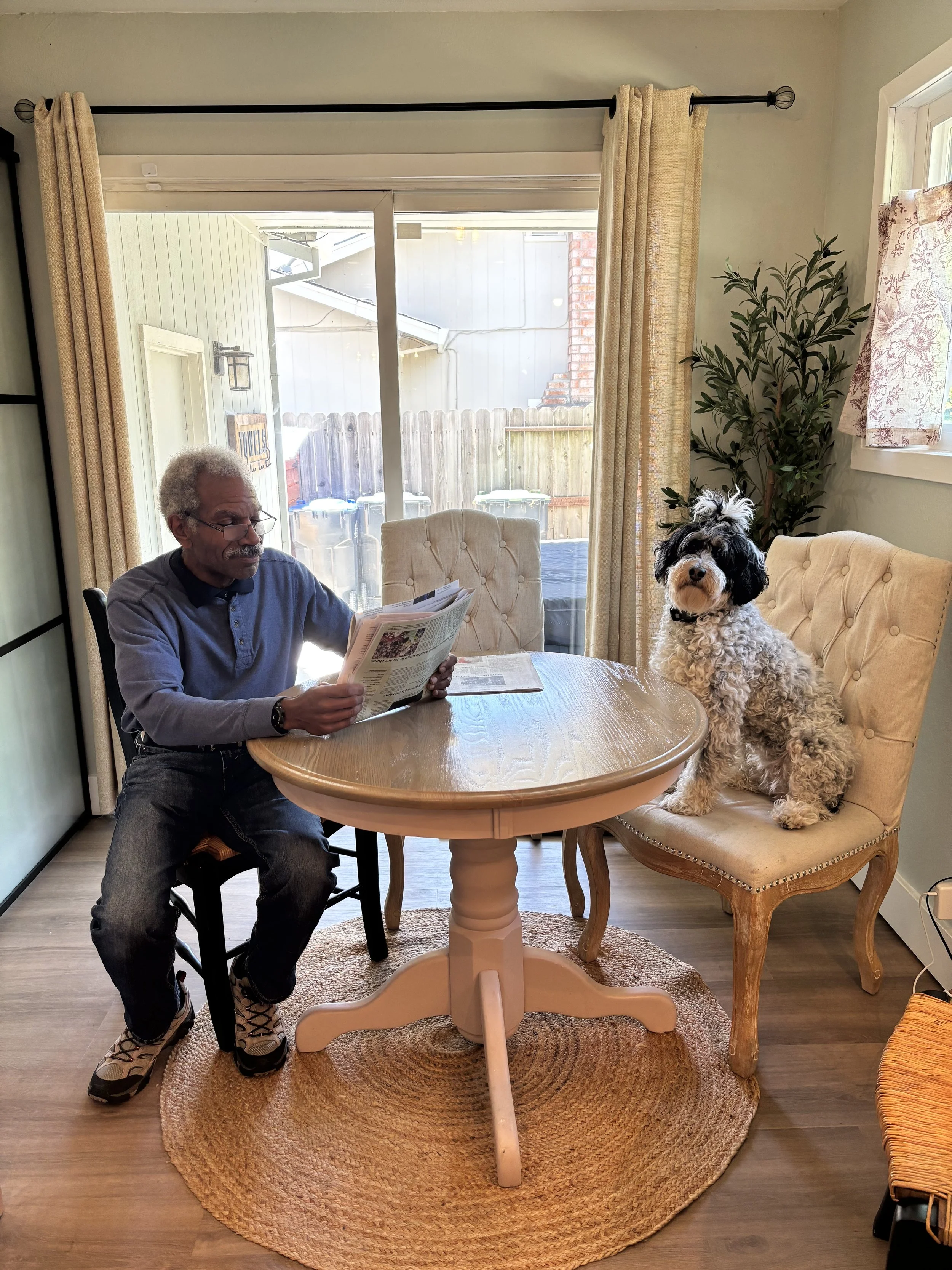 Senior enjoying pet therapy with a dog at Rebekah’s Retreat adult day care program in Fairfield, California.