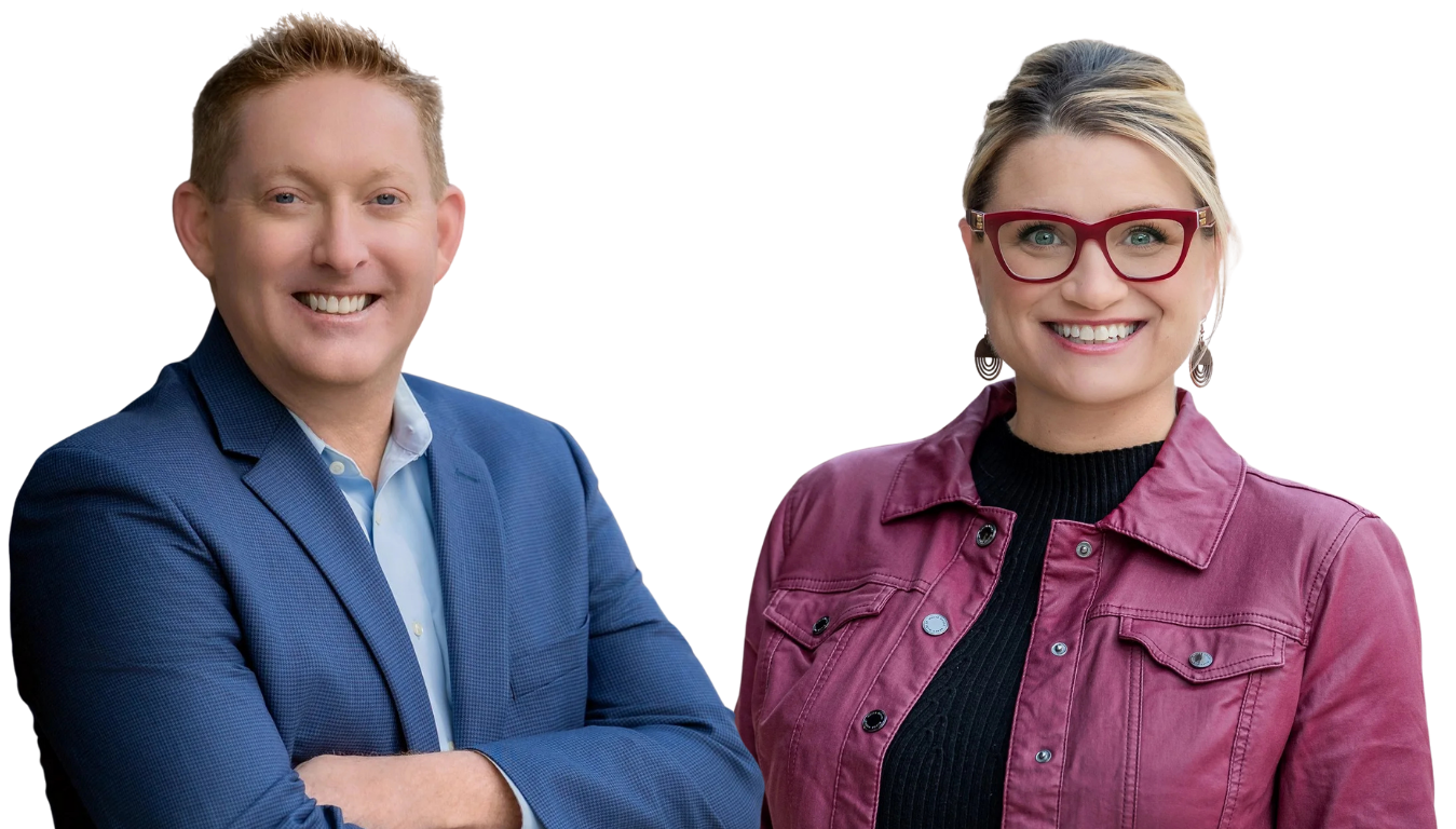 Brian and Amy Thompson of LINQ EAP smiling, standing side by side. The man has short, light hair and is wearing a blue blazer over a light blue shirt. The woman has blonde hair, is wearing red glasses, a black top, and a maroon jacket.