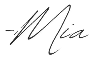 A black brushstroke signature with the name Mia written in a cursive style.