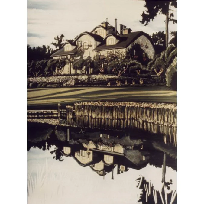 A large house with multiple gabled roofs, surrounded by trees, with a garden in front and a body of water reflecting the house and garden.