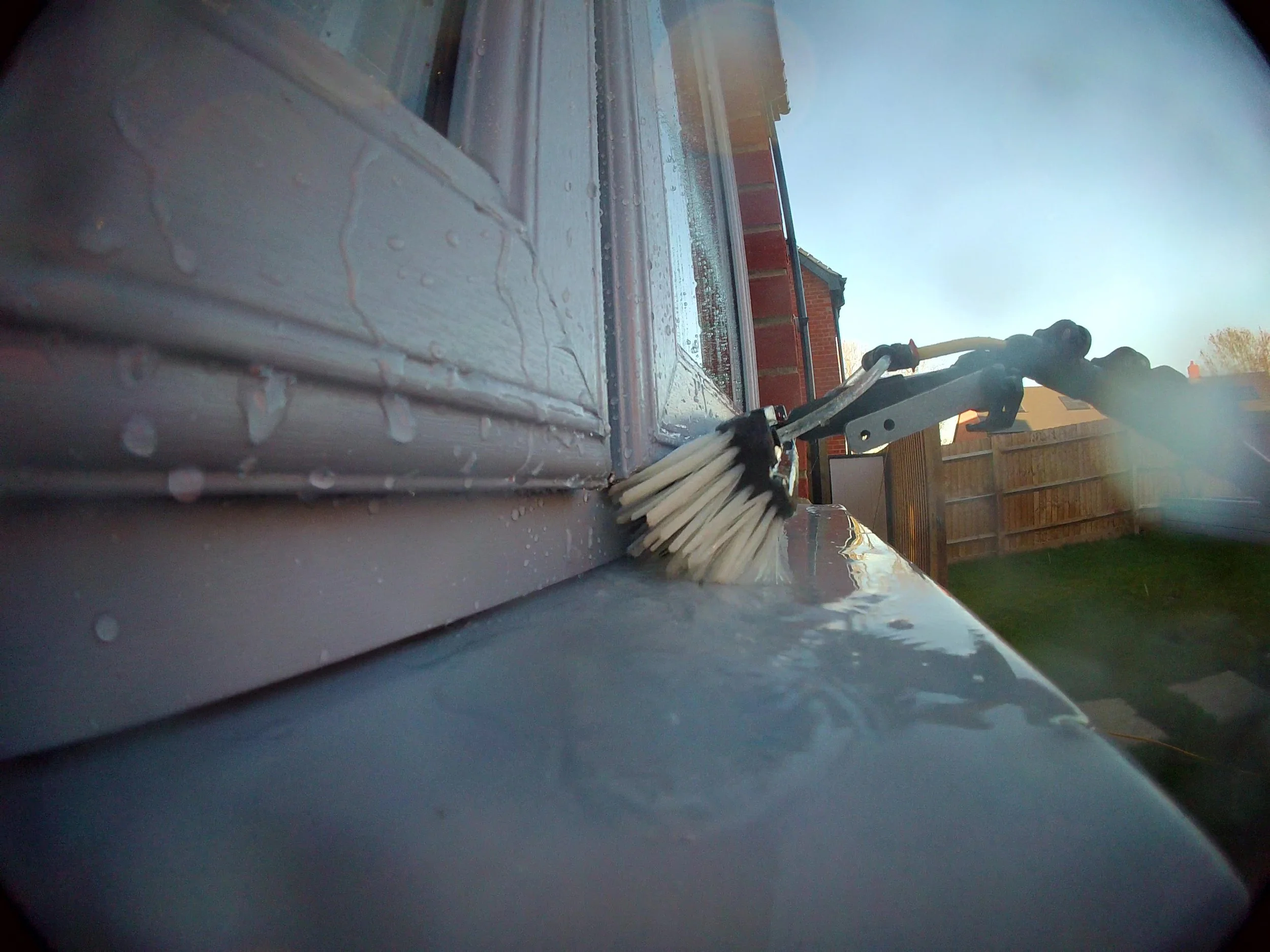 Close up of window sill cleaning using pure water fed pole system Colchester.