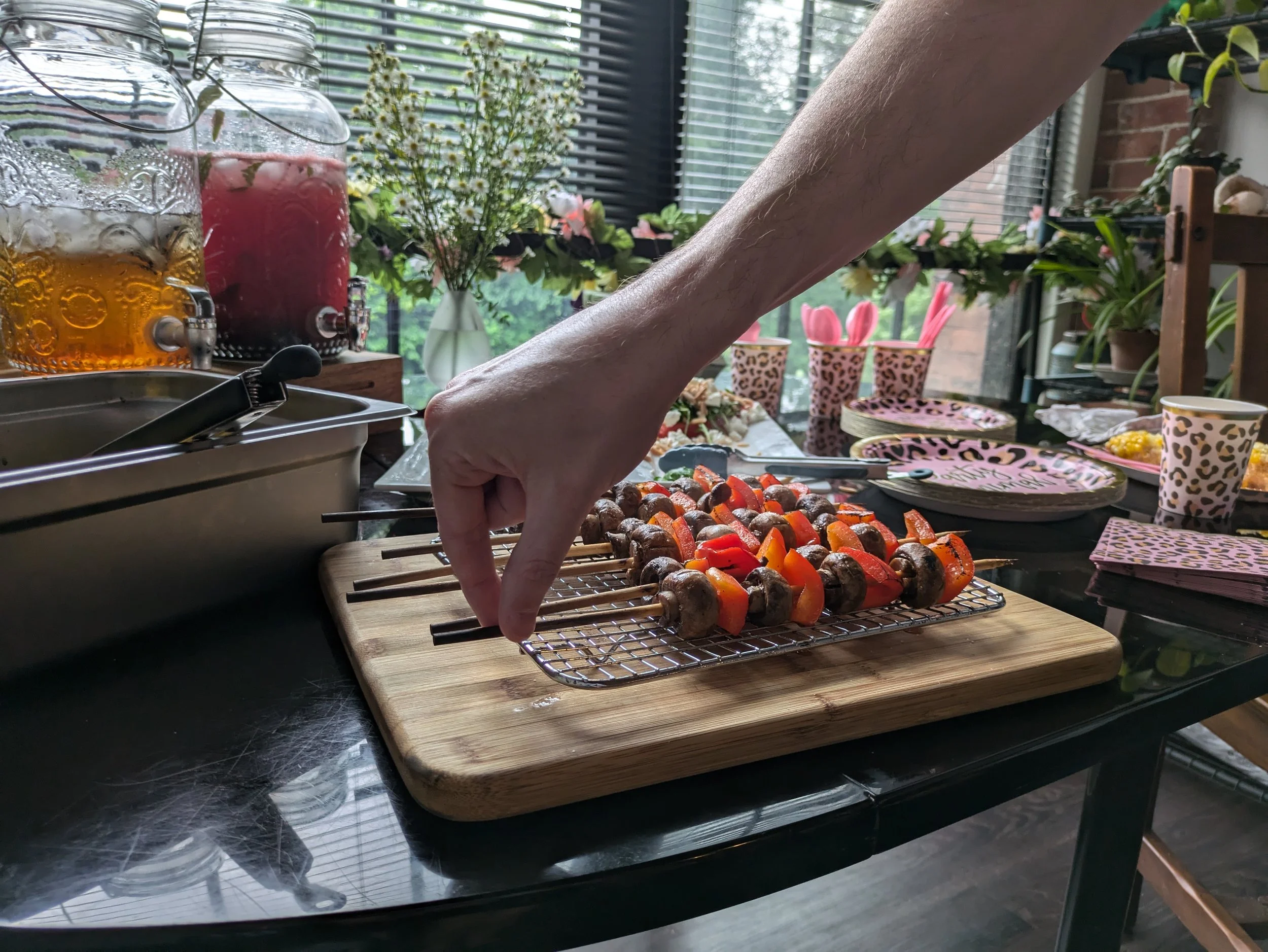 A hand reaching for a veggie skewer - private event chef