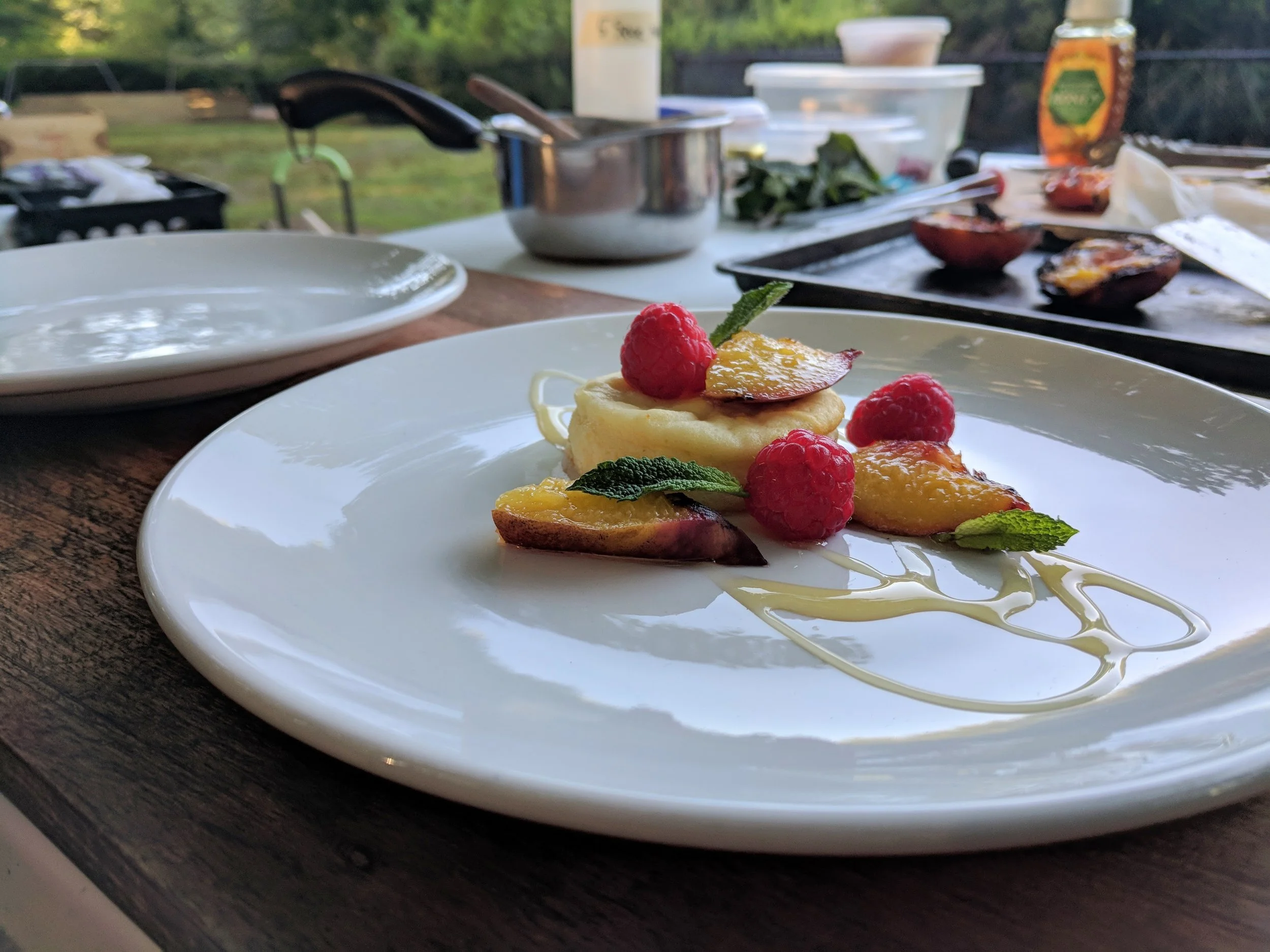 Ricotta cake with grilled peach, fresh raspberry, honey, and mint