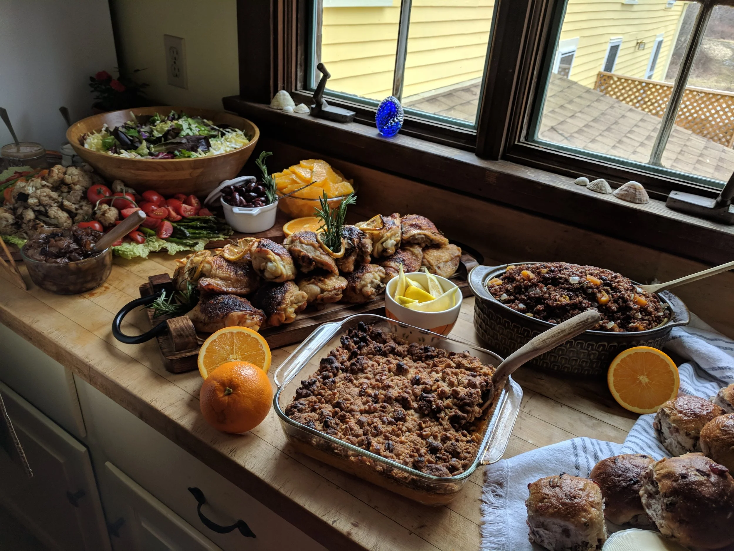 A full lunch spread of roast chicken, grilled vegetables, quinoa salad, sweet potato casserole, and more