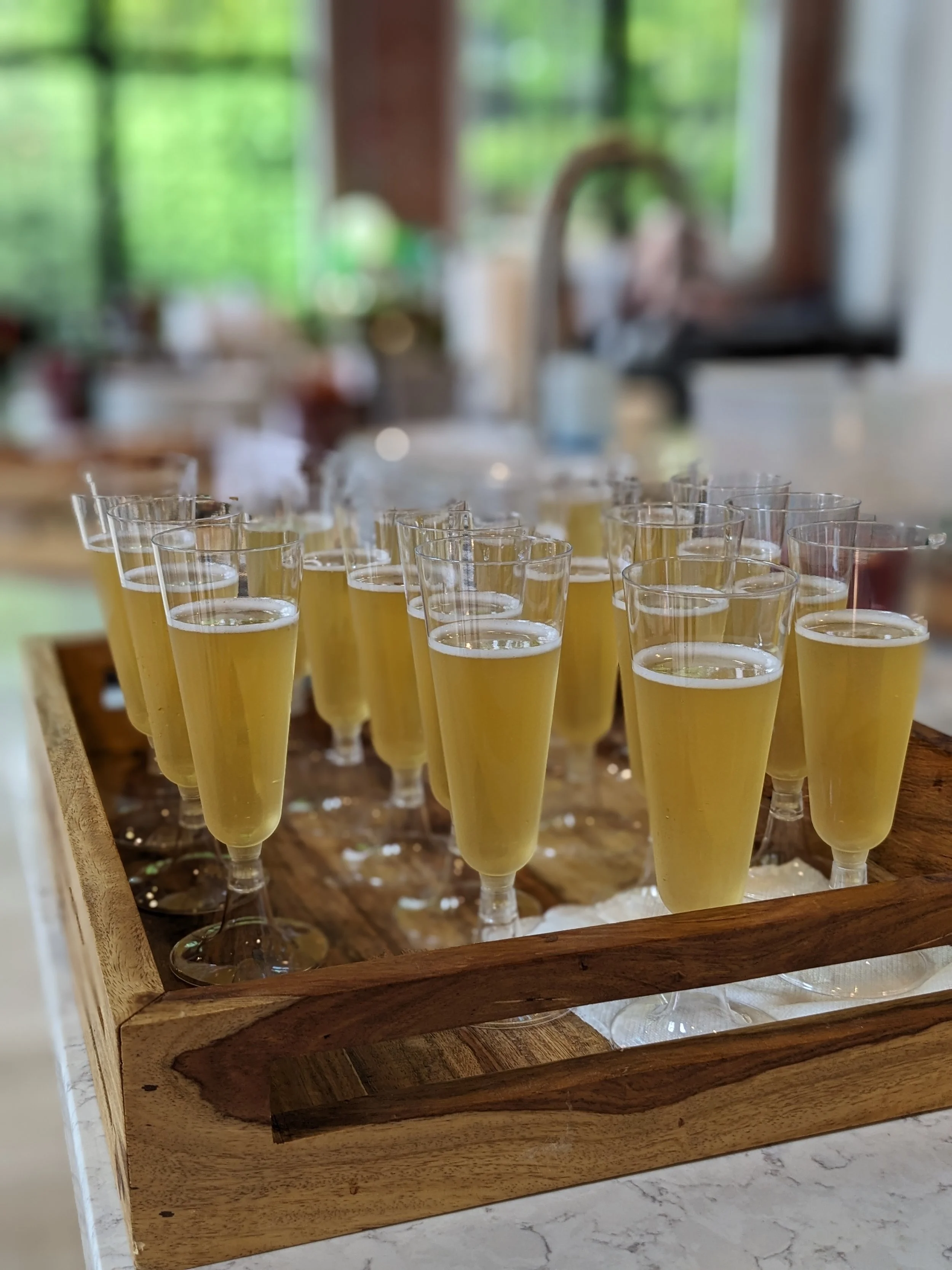 A tray of sparkling beverages ready for a toast - birthday parties MA
